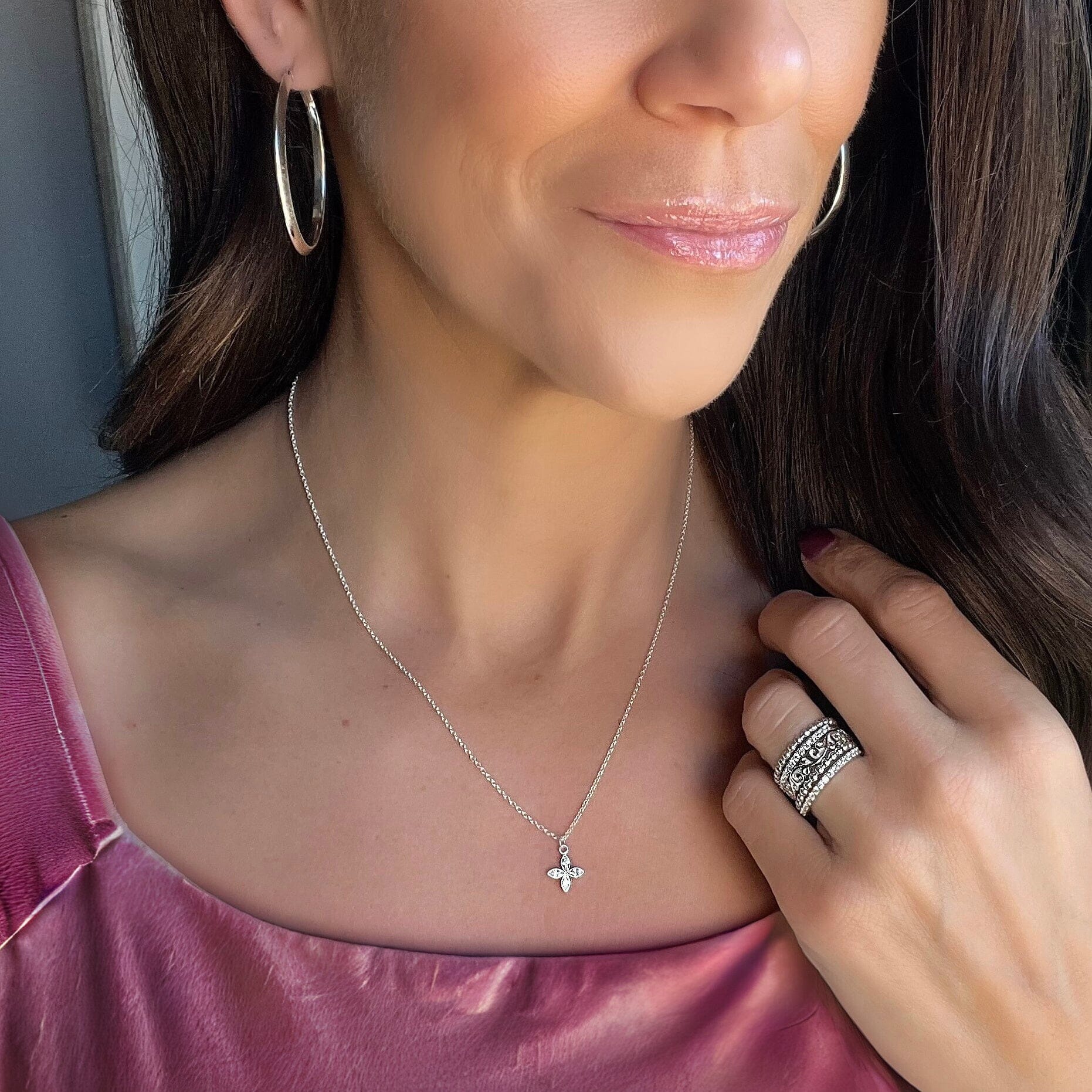 dainty sterling silver necklace featuring a four-petal CZ flower pendant