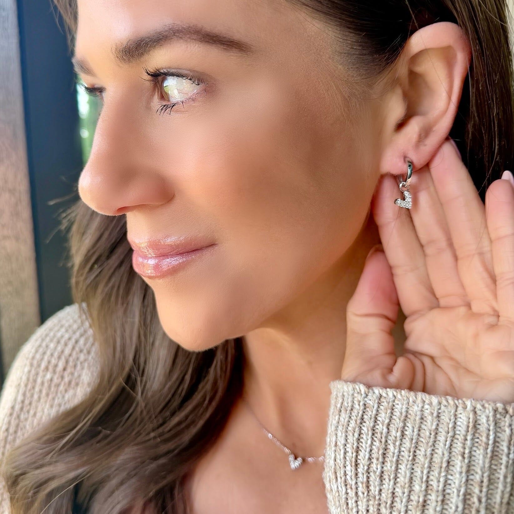 huggie earrings with cz heart dangle
