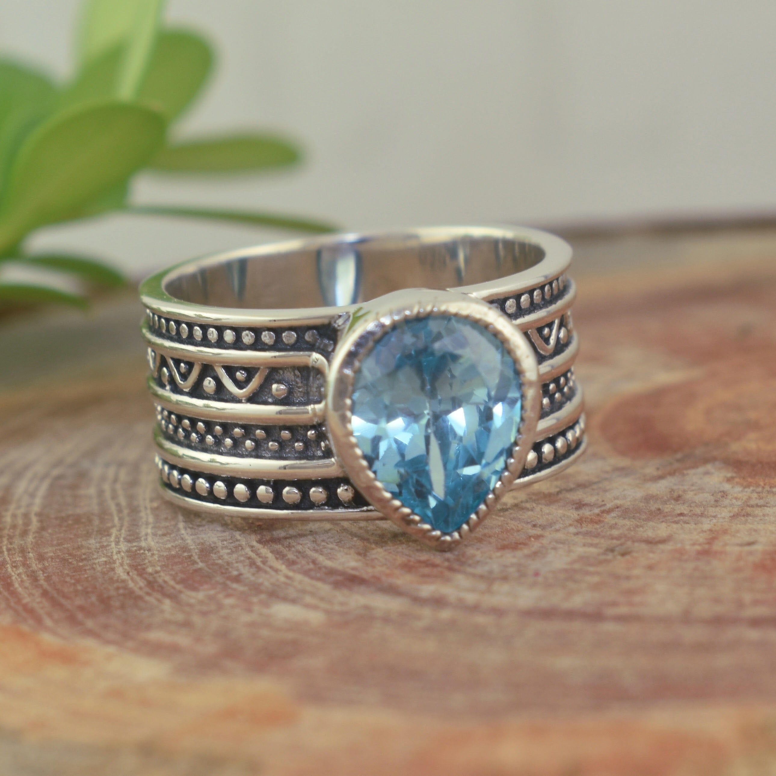 .925 sterling silver wide band ring with pear-shaped swiss blue cubic zirconia stone