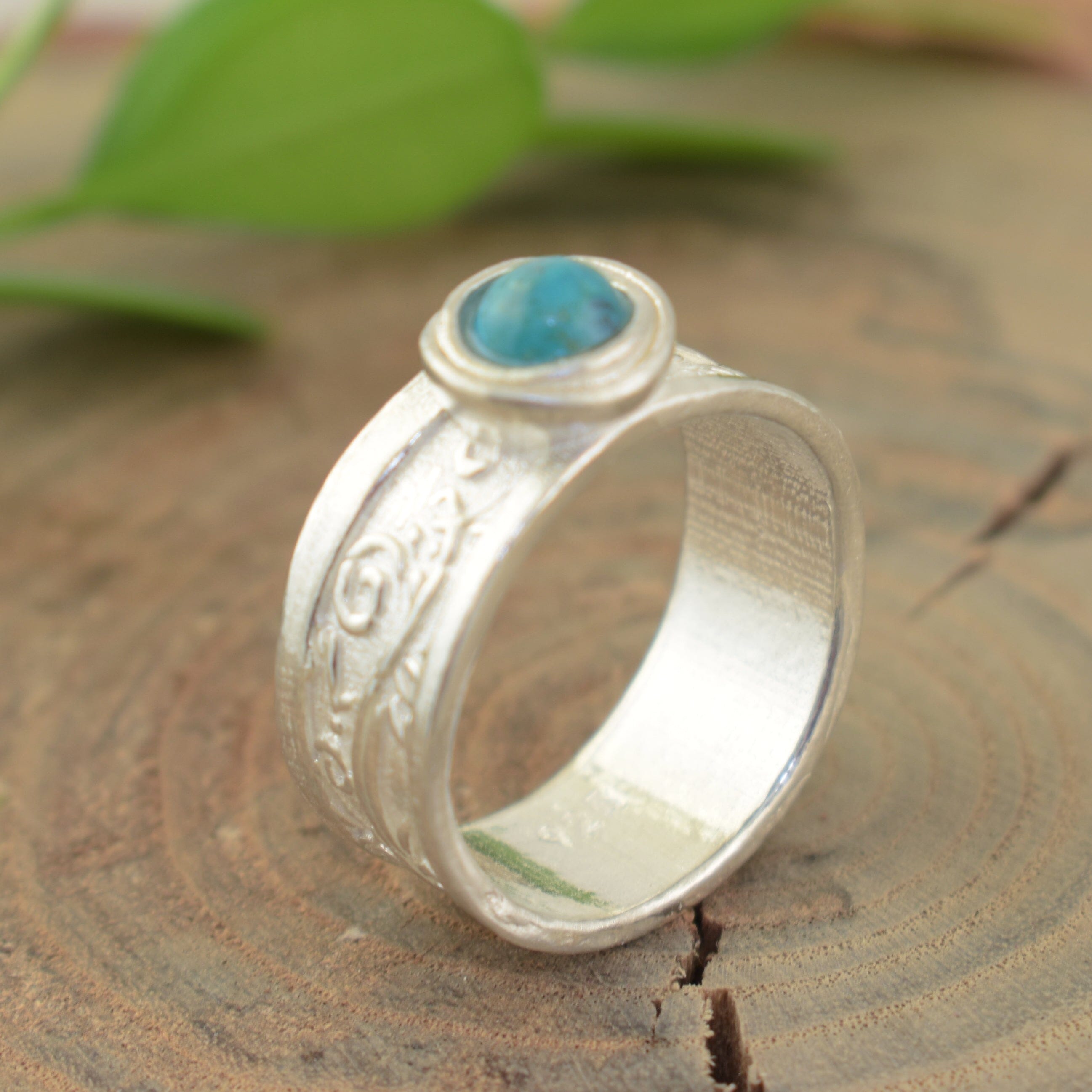 Swirled band ring with blue-green turquoise stone