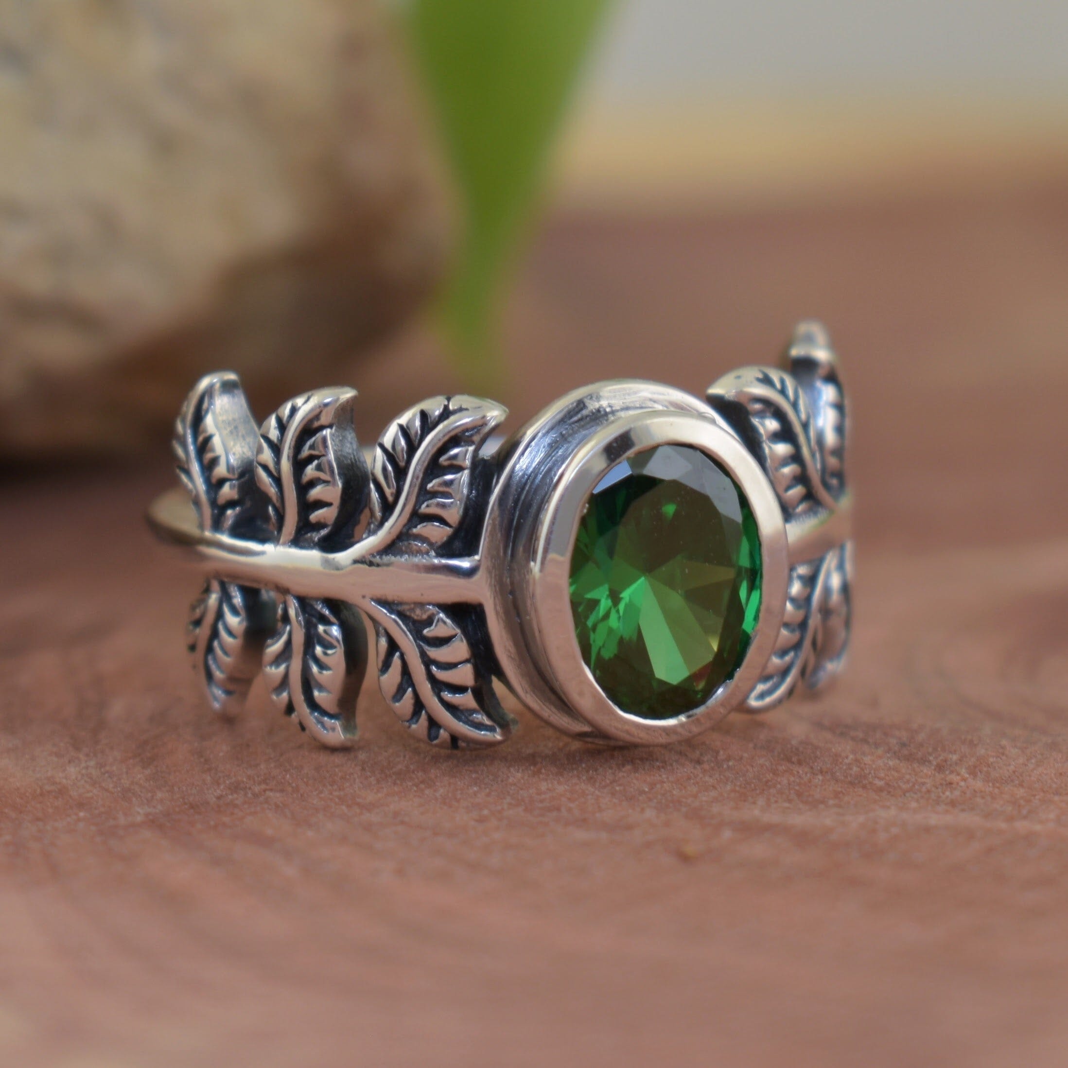 sterling silver and oval emerald CZ handcrafted with a palm leaf style band