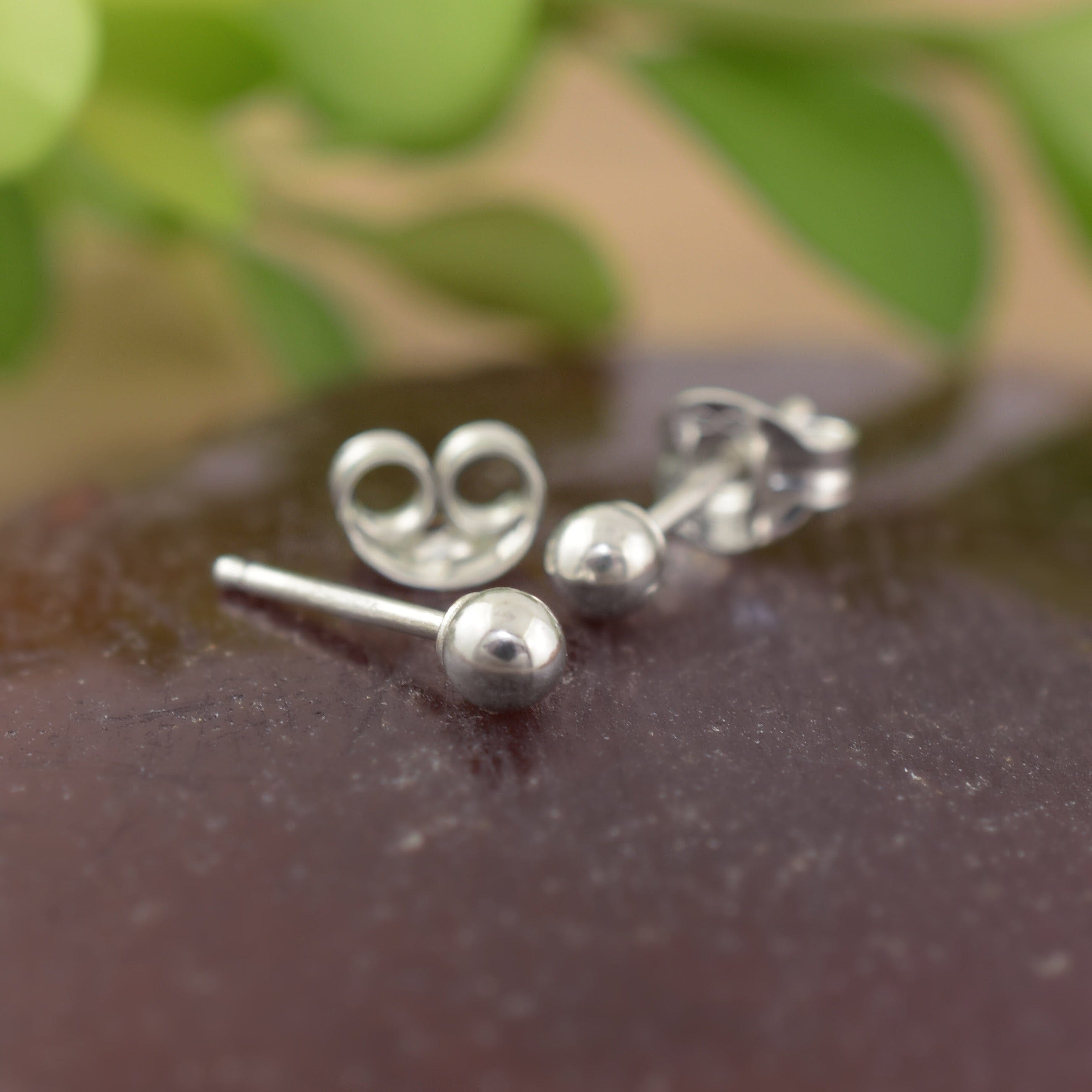 A pair of sterling silver small dot stud earrings