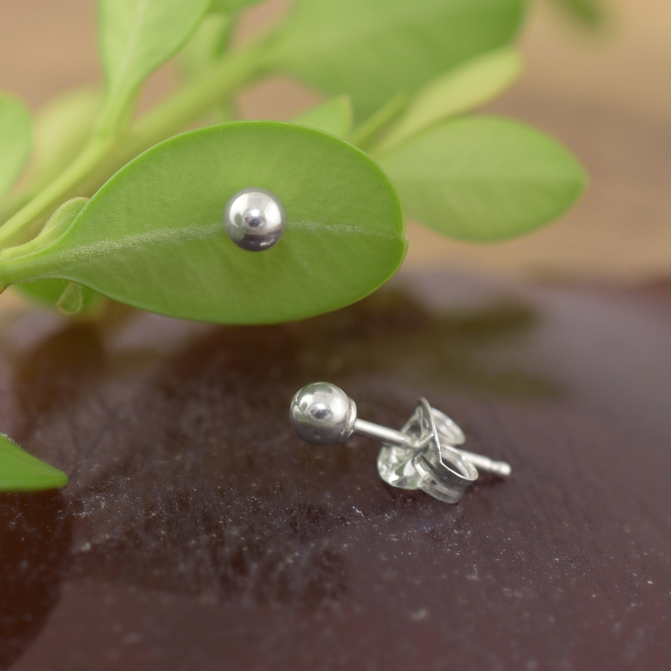 A pair of sterling silver small dot stud earrings