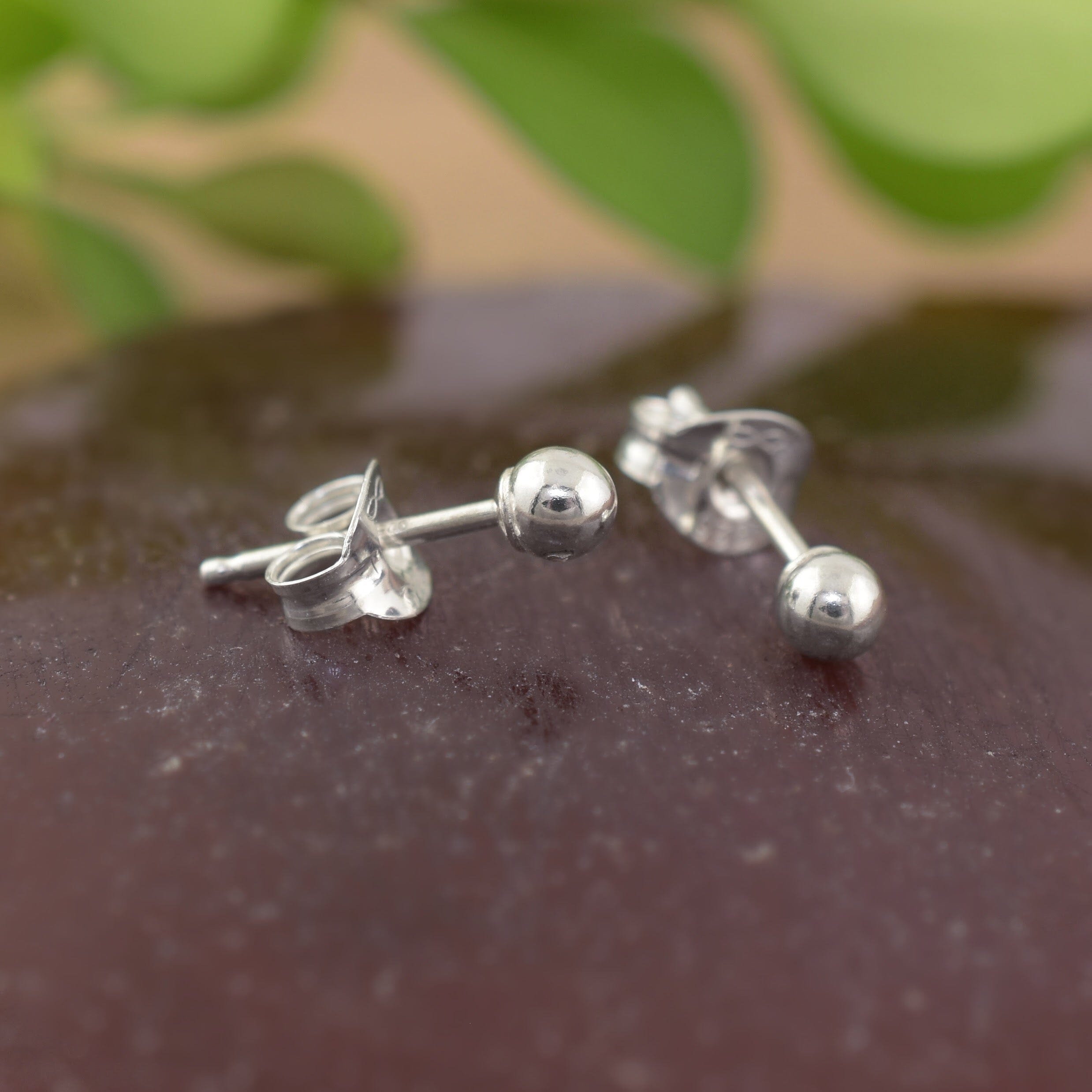 A pair of sterling silver small dot stud earrings