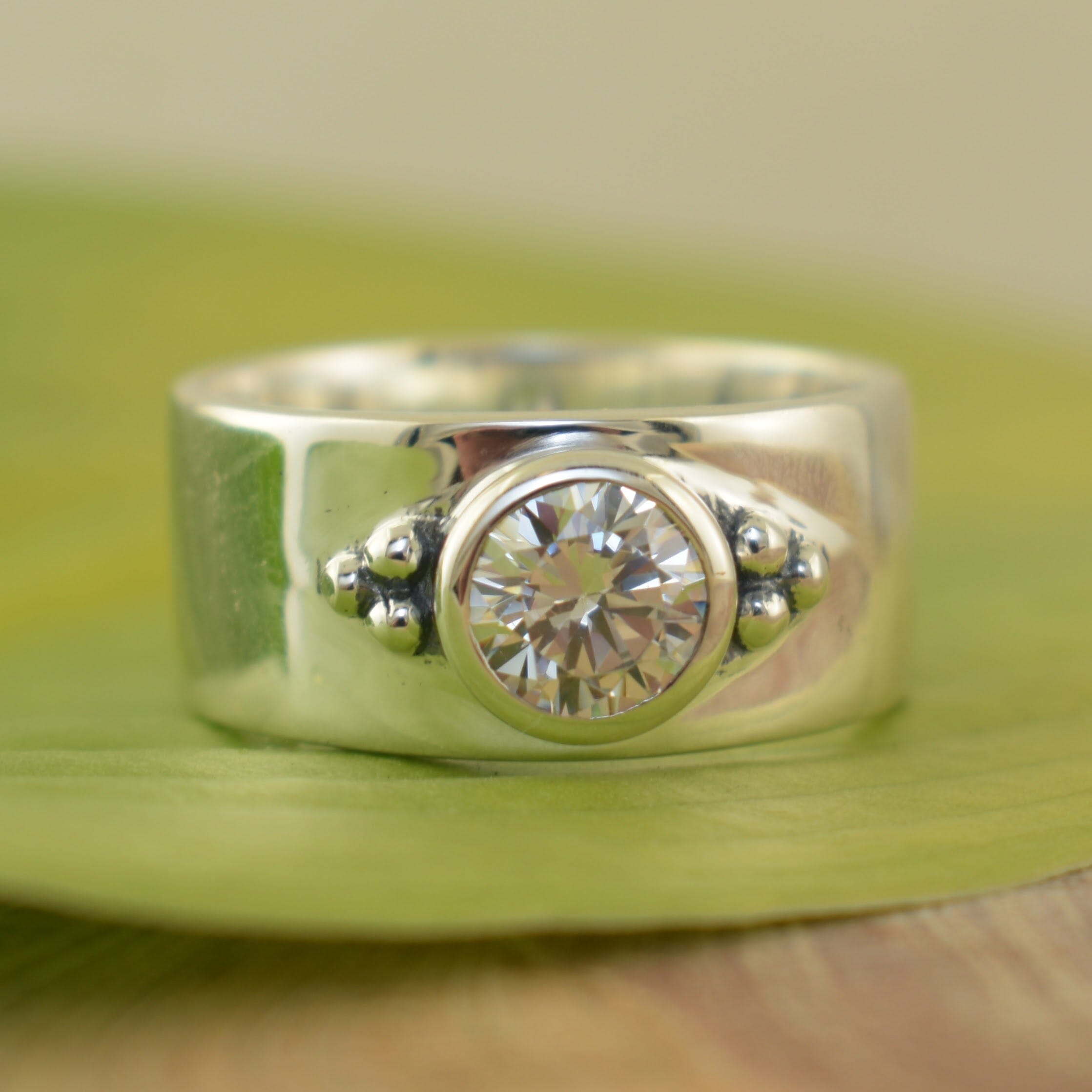 high polished sterling silver ring with a Clear CZ stone with 3 silver beads on each side