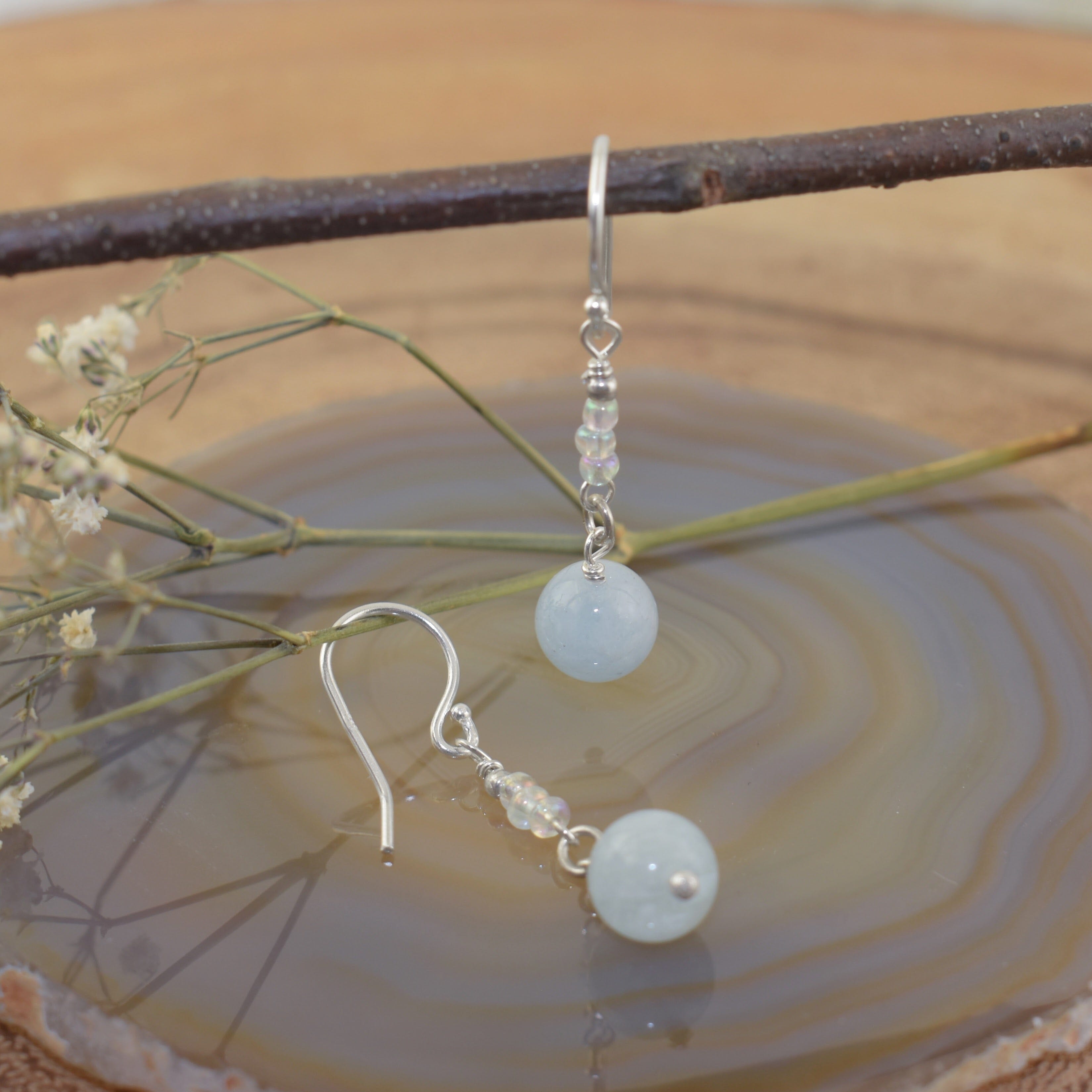 A pair of sterling silver drop earrings with milky aqua round beads and small glass spacer beads