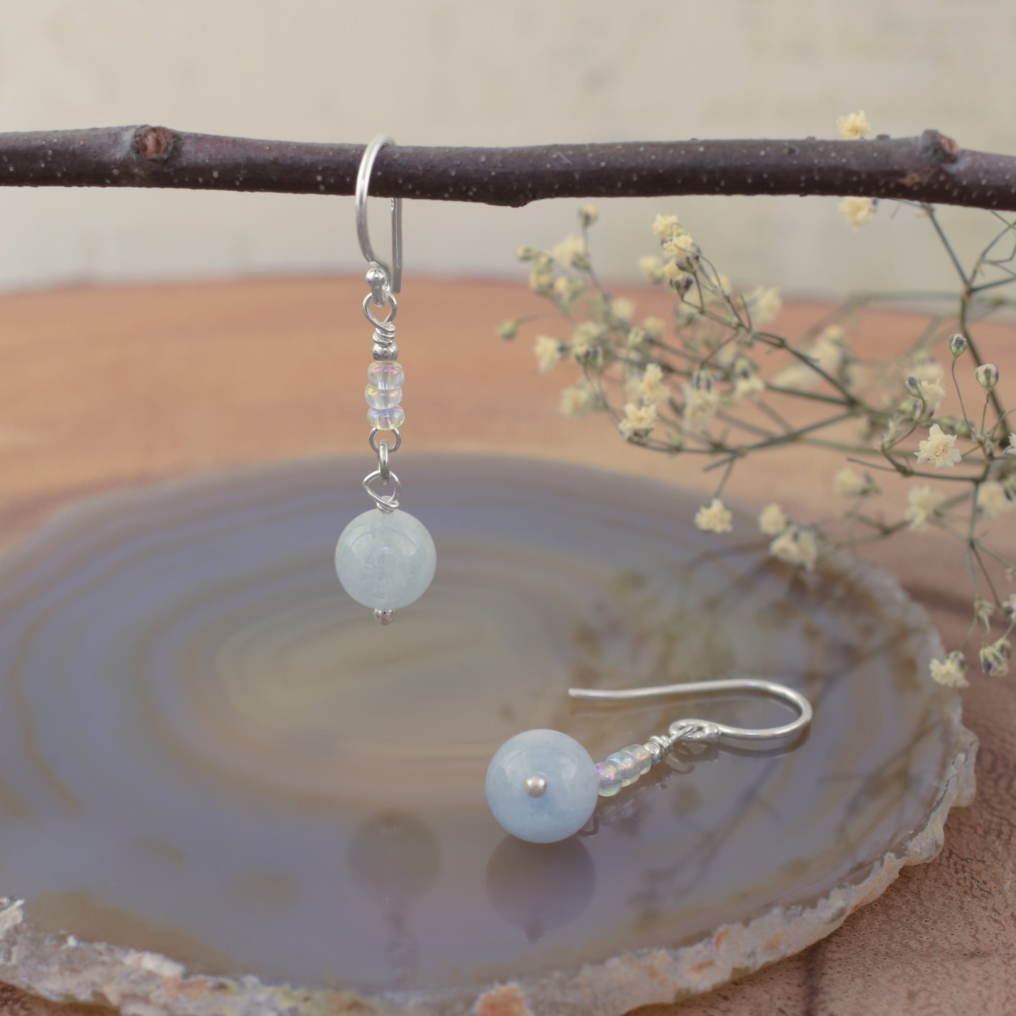 A pair of sterling silver drop earrings with milky aqua round beads and small glass spacer beads