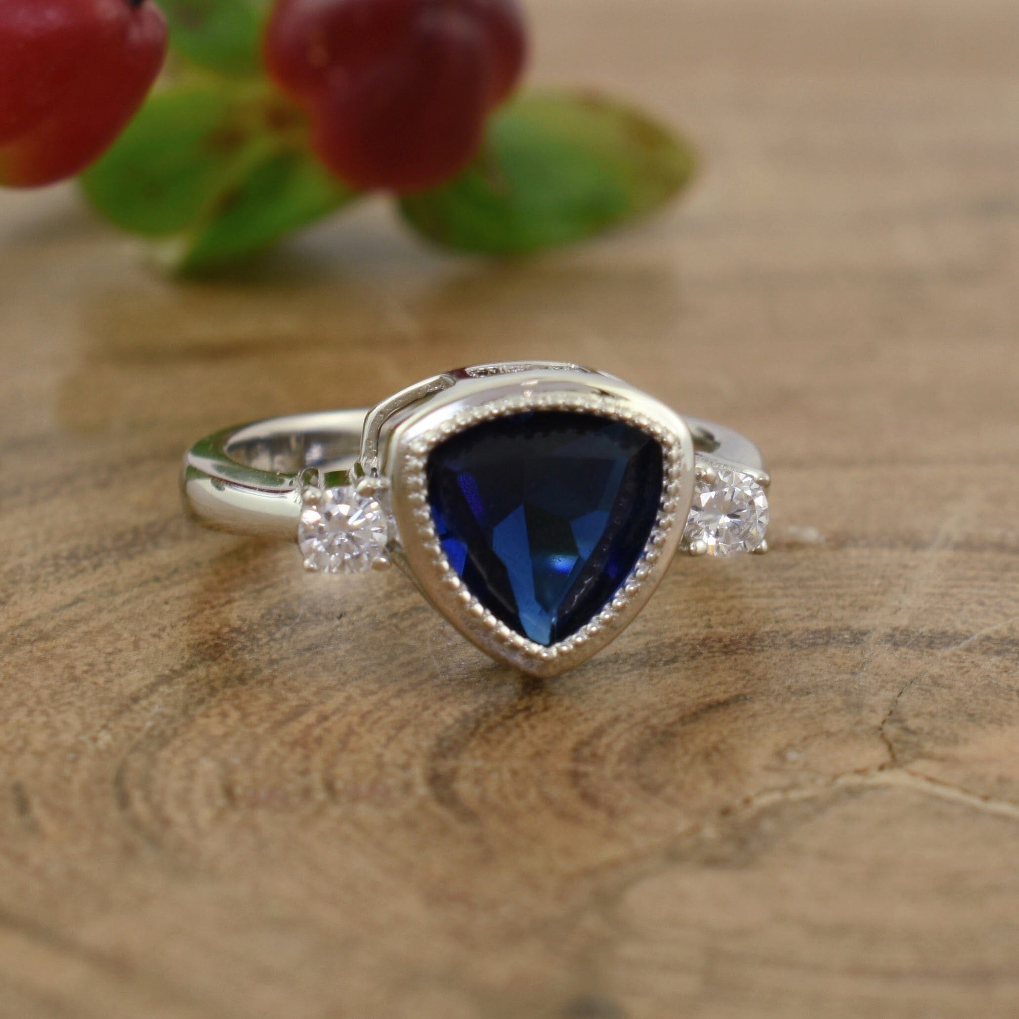 Designer ring featuring sterling silver, faux blue sapphire, and CZ
