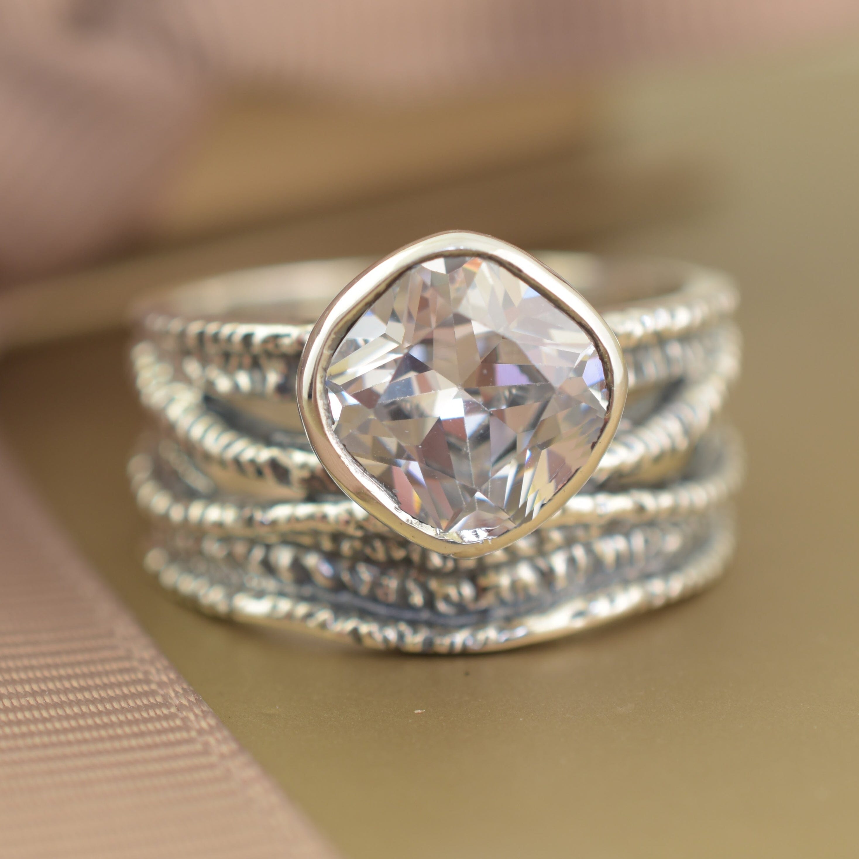 Bezel-set cushion-cut CZ and sterling silver wide band ring