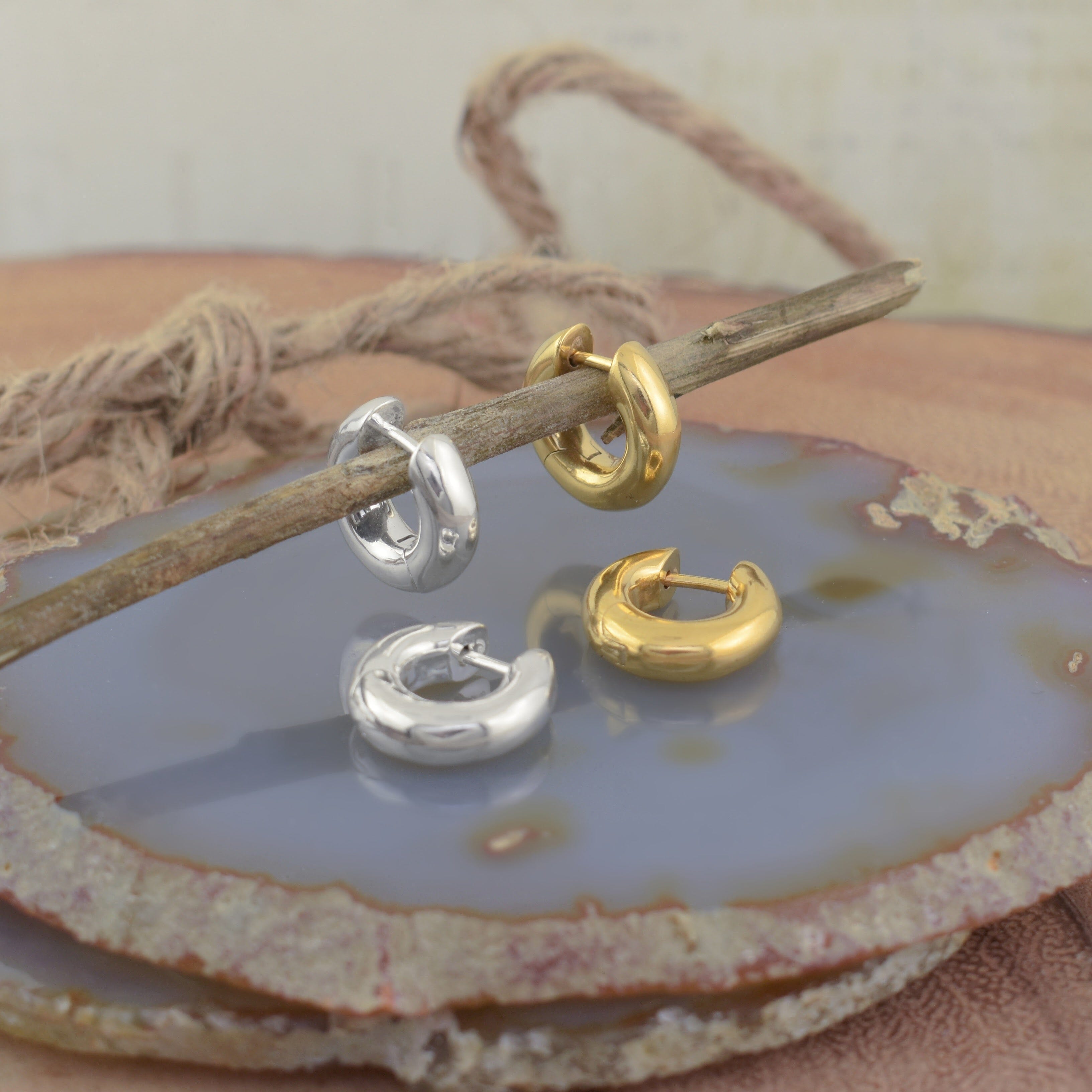 Four small huggie hoop earrings in polished silver and gold 
