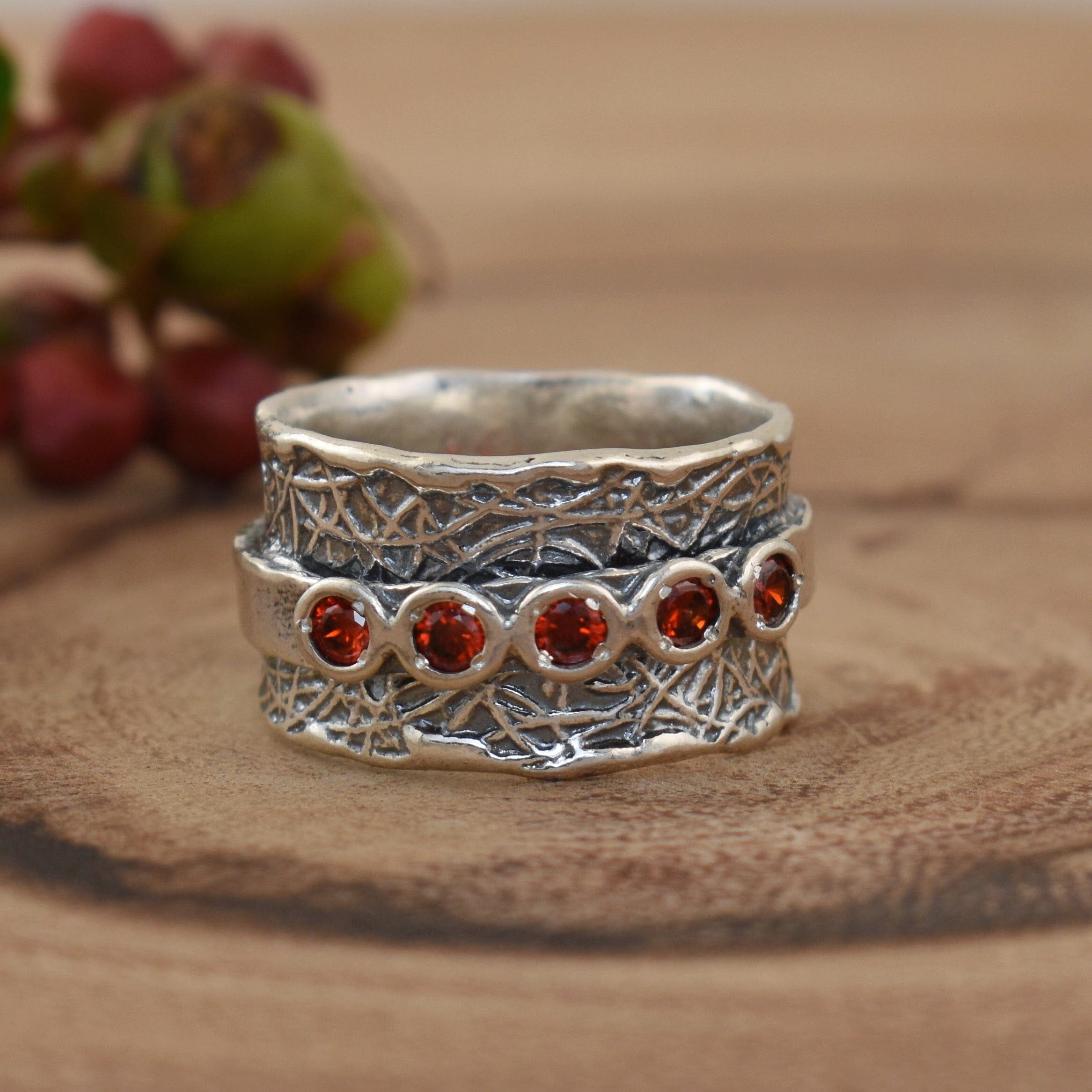 Sterling silver spinner band ring with carnelian colored cz stones