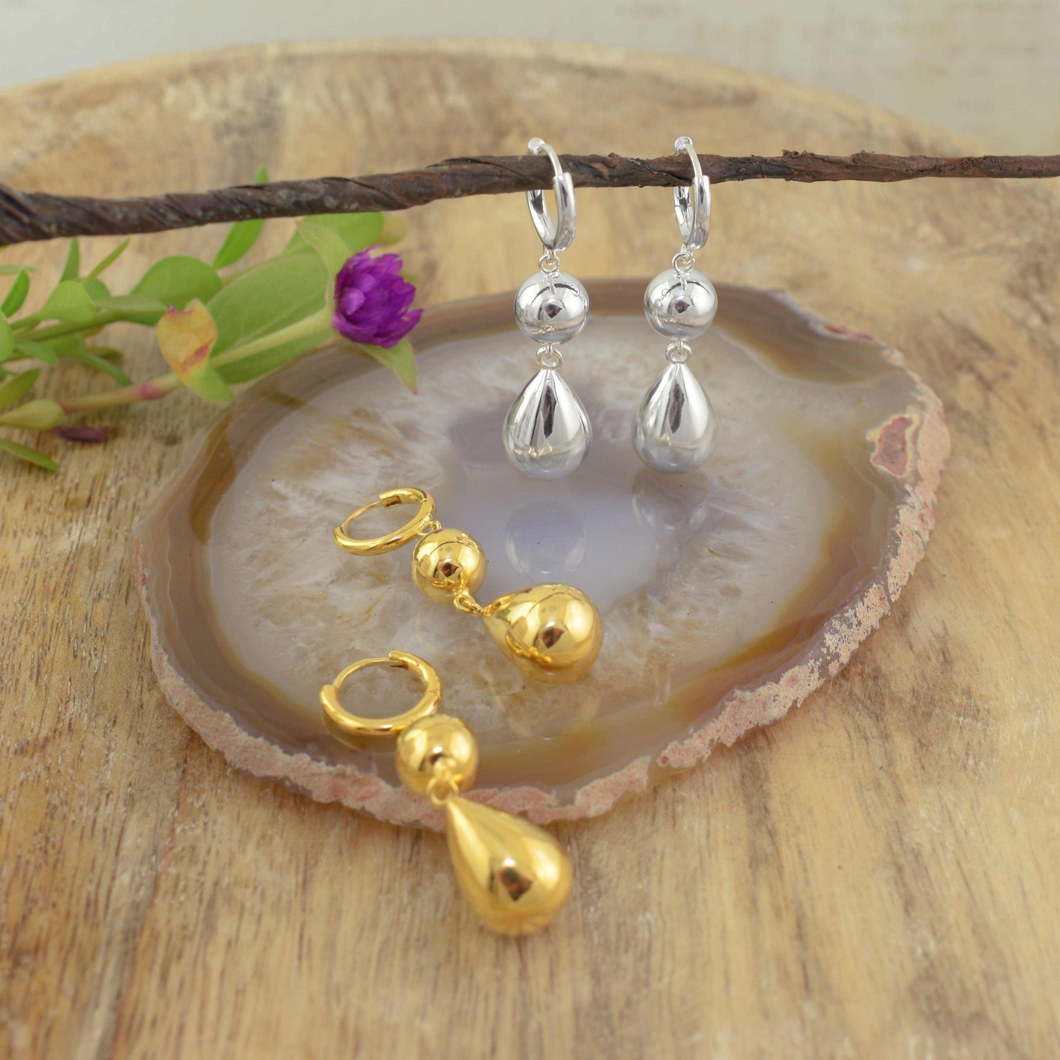 two pairs of gold and silver teardrop dangle earrings in a high polish finish