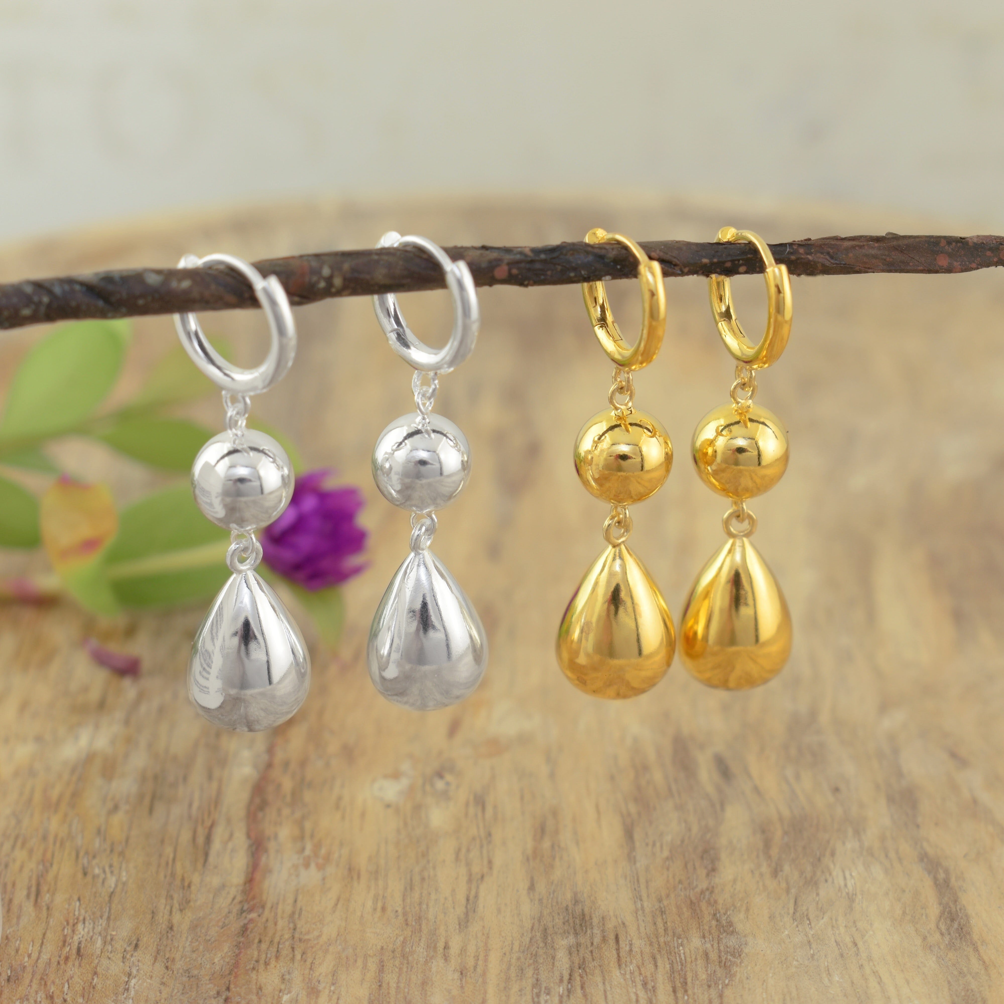 two pairs of gold and silver teardrop dangle earrings in a high polish finish
