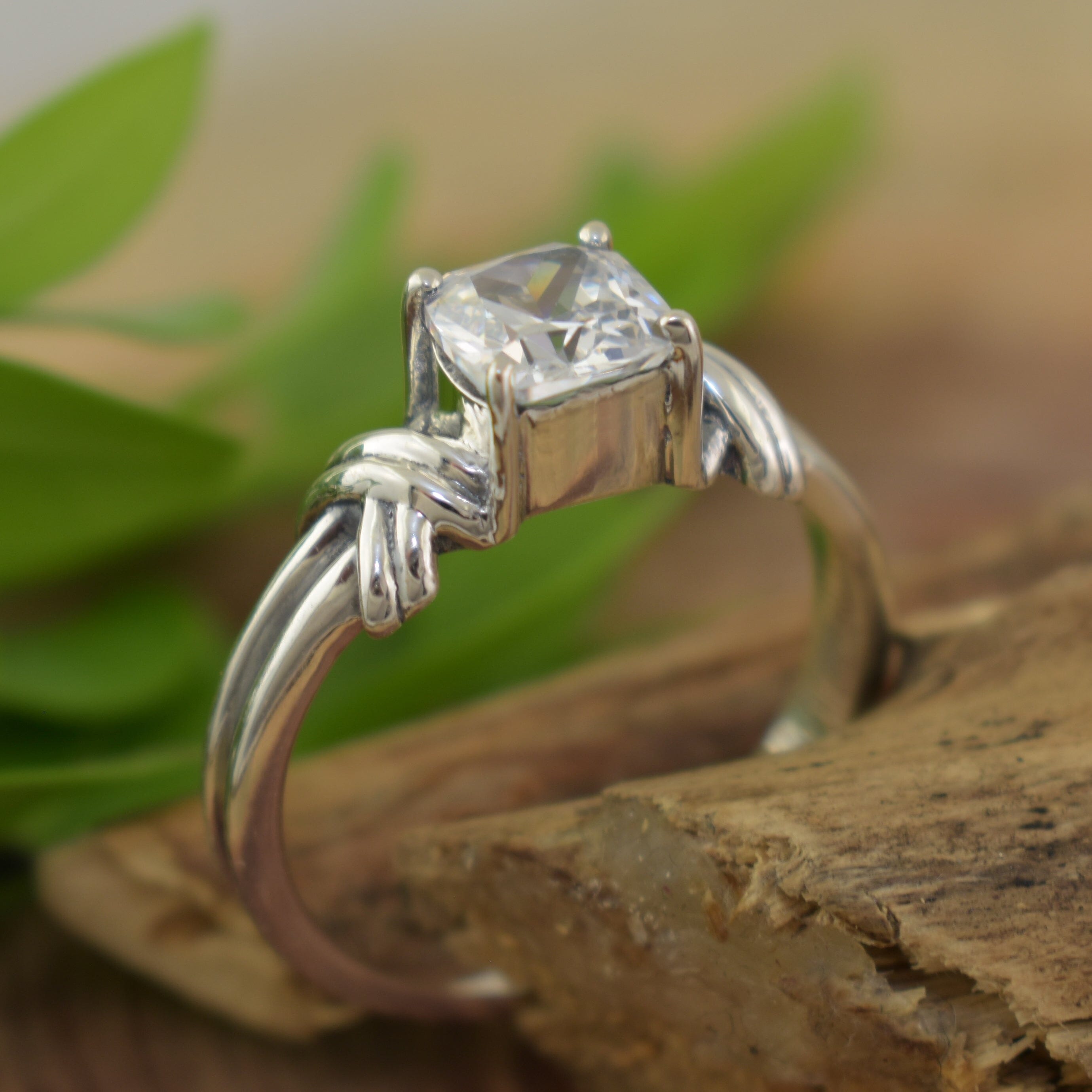 Engagement style sterling silver ring featuring cushion-cut clear cz stone
