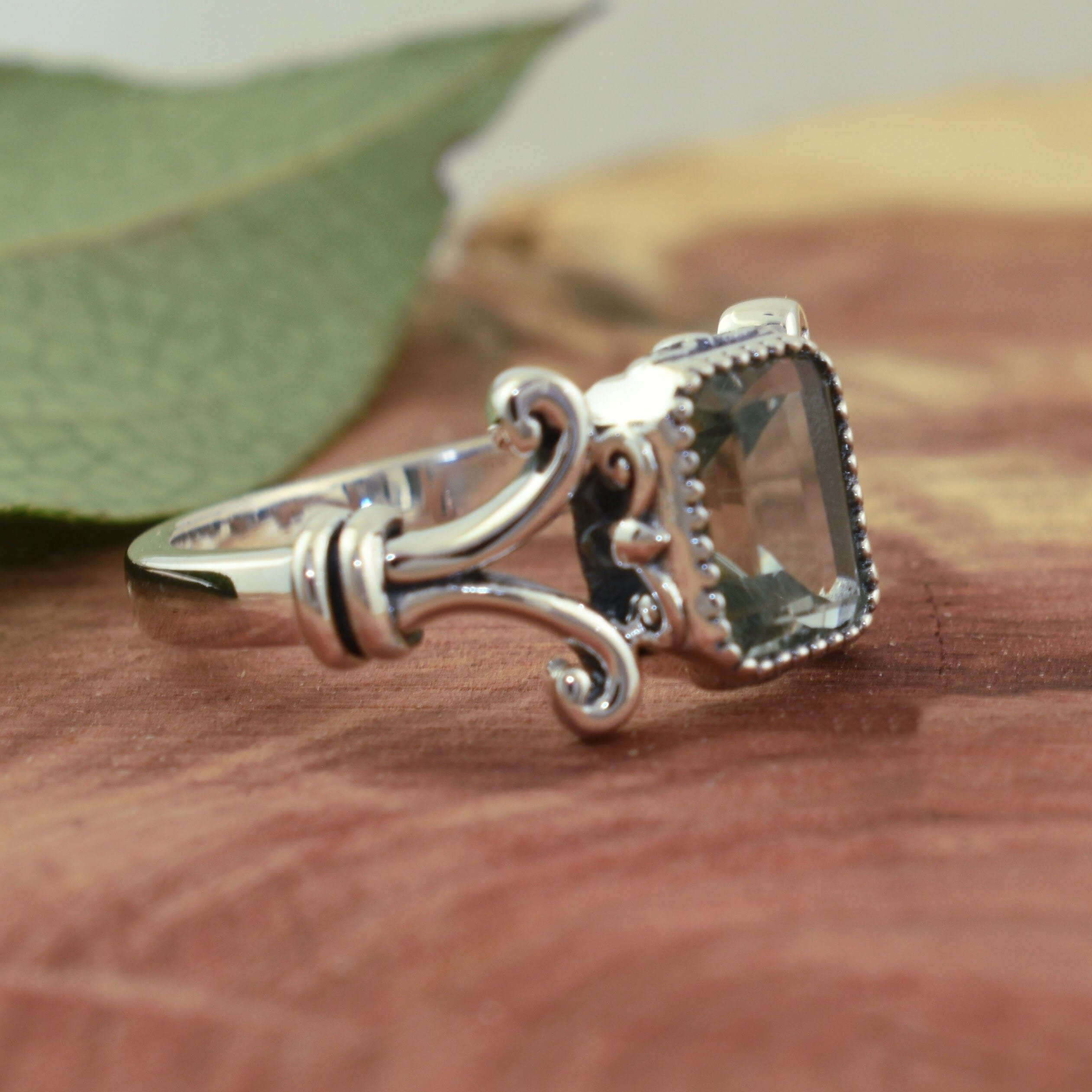 vintage designer ring with a bezel set emerald cut stone