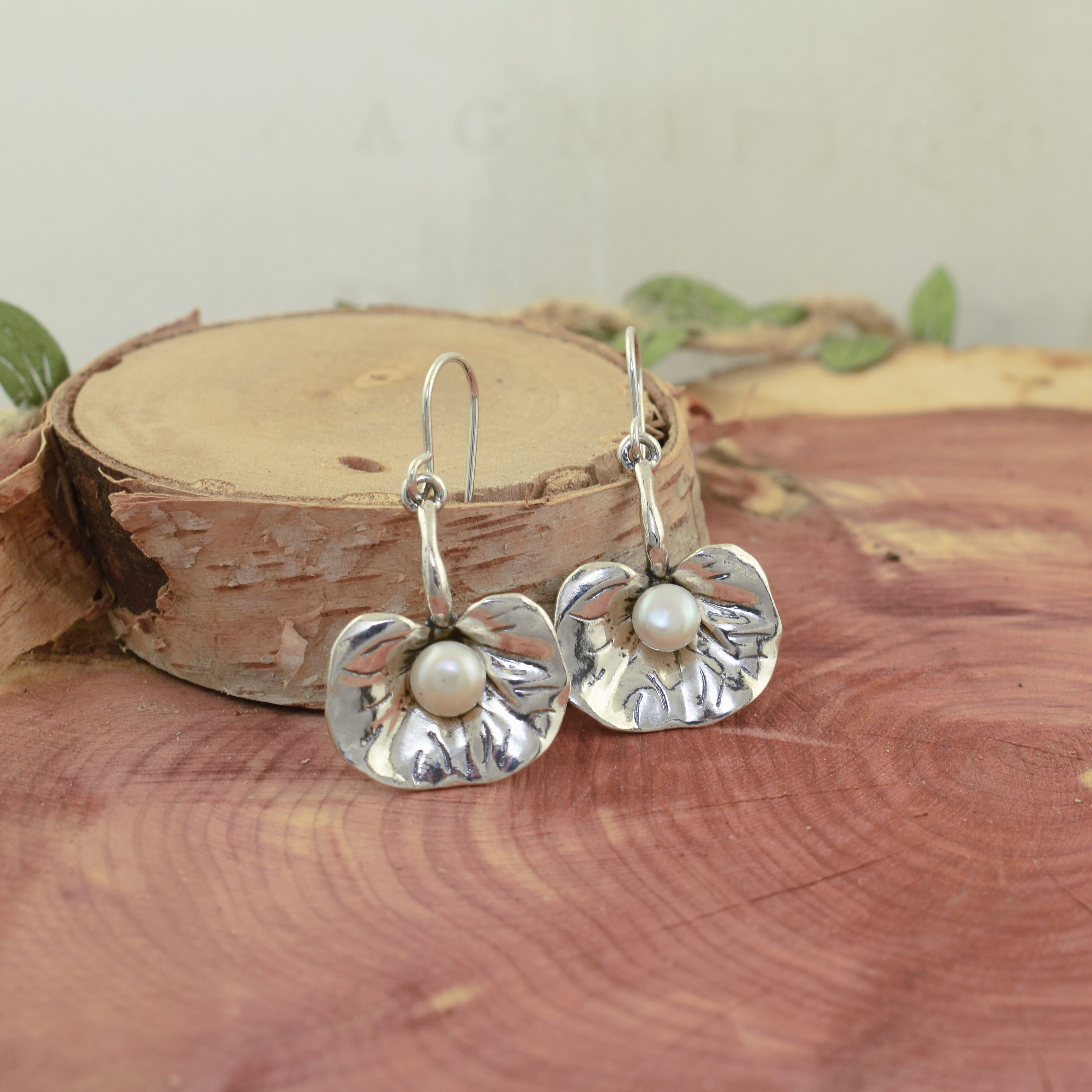 Freshwater pearl earrings set in sterling silver lily pad design