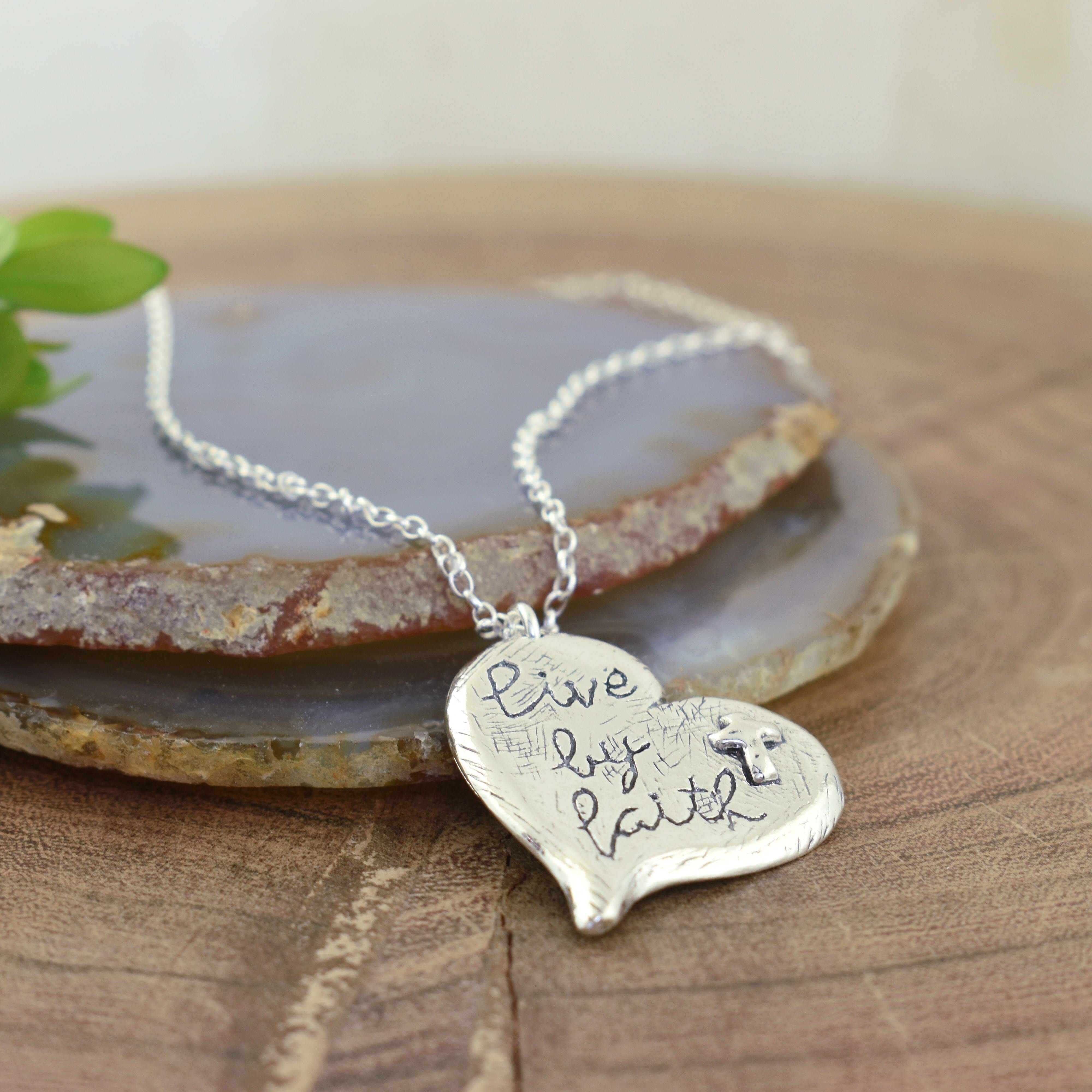 Sterling silver necklace engraved with words "Live By Faith"