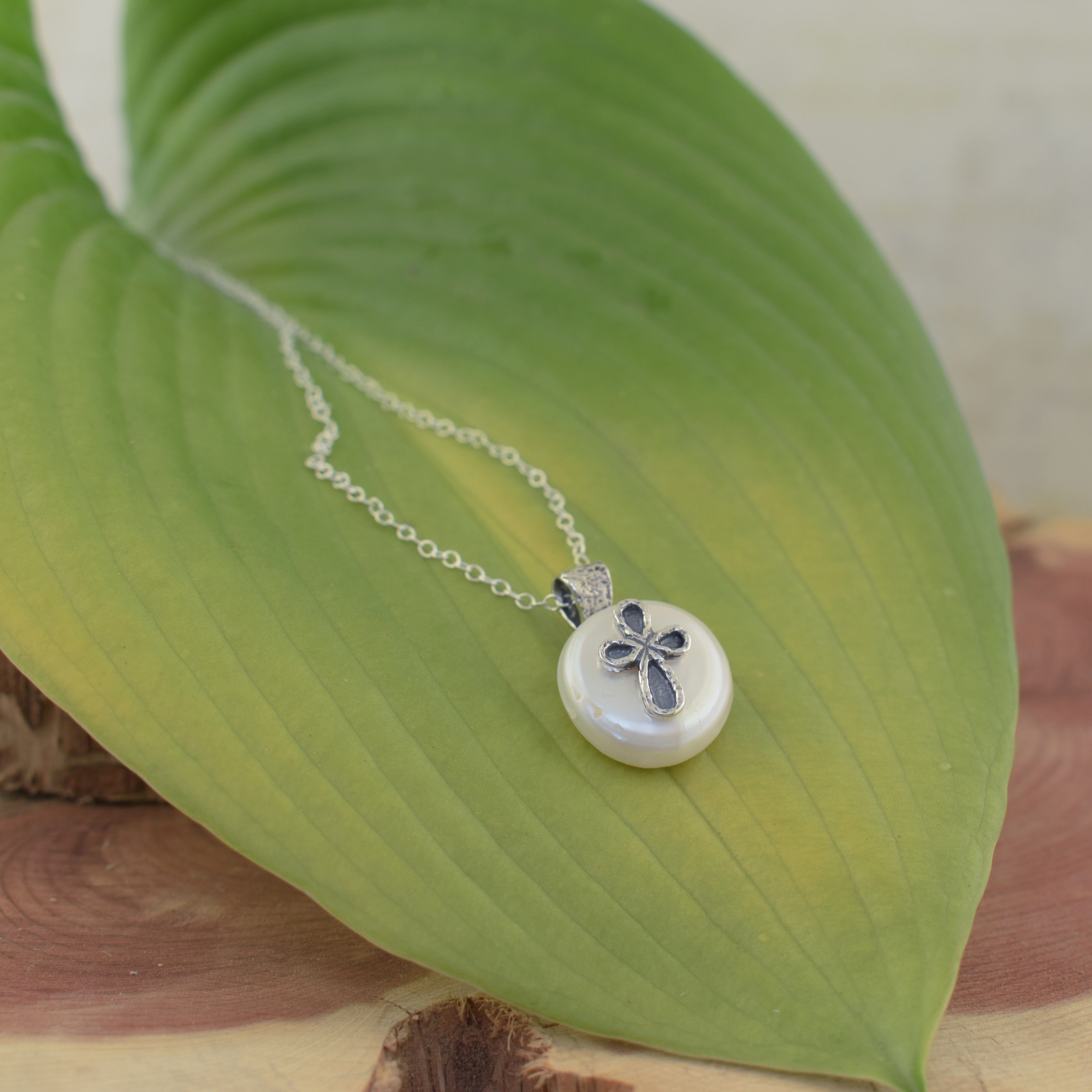 handcrafted necklace with a freshwater pearl and a sterling silver cross