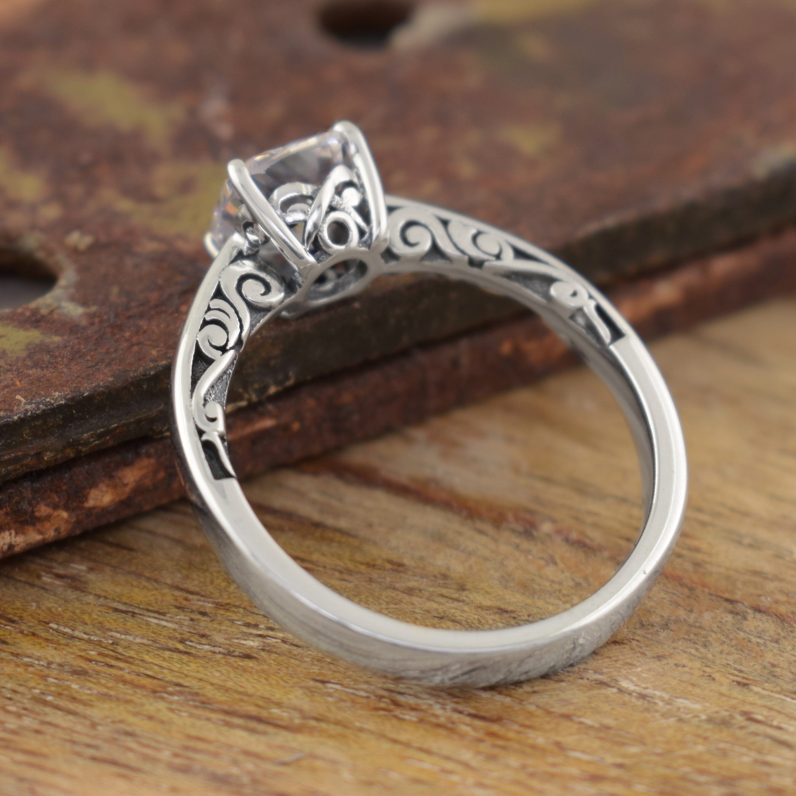 a sterling silver filigree ring with a clear square gemstone