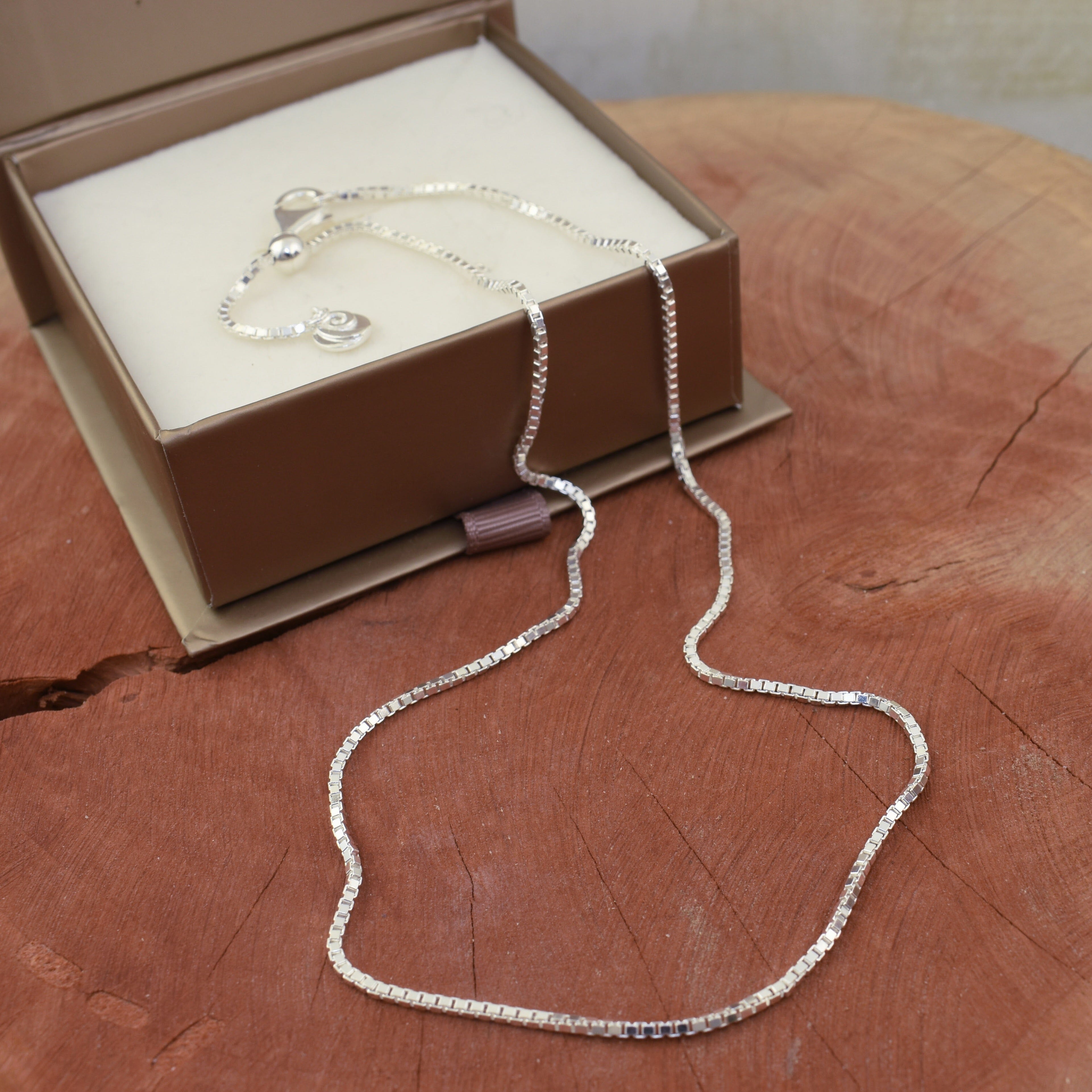 high polished box chain with a sliding bead for adjusting the length