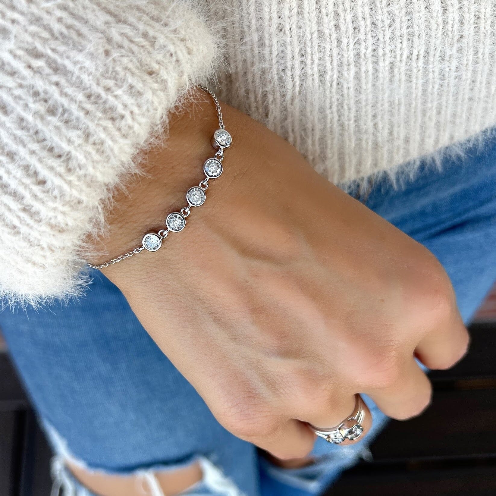 dainty sterling silver bracelet featuring 5 round cubic zirconia