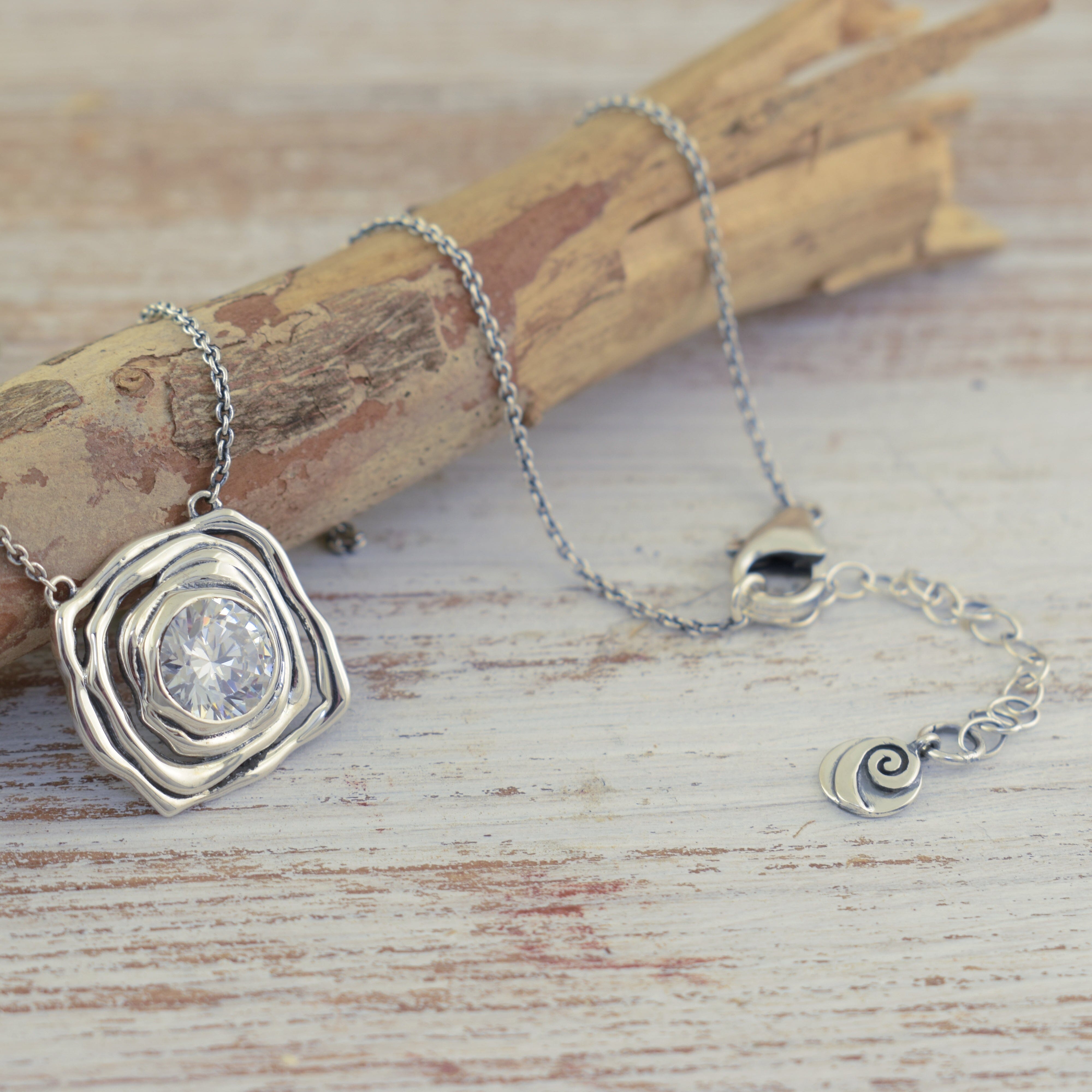 Organic sterling silver style necklace with clear cz stone and Inspiranza logo