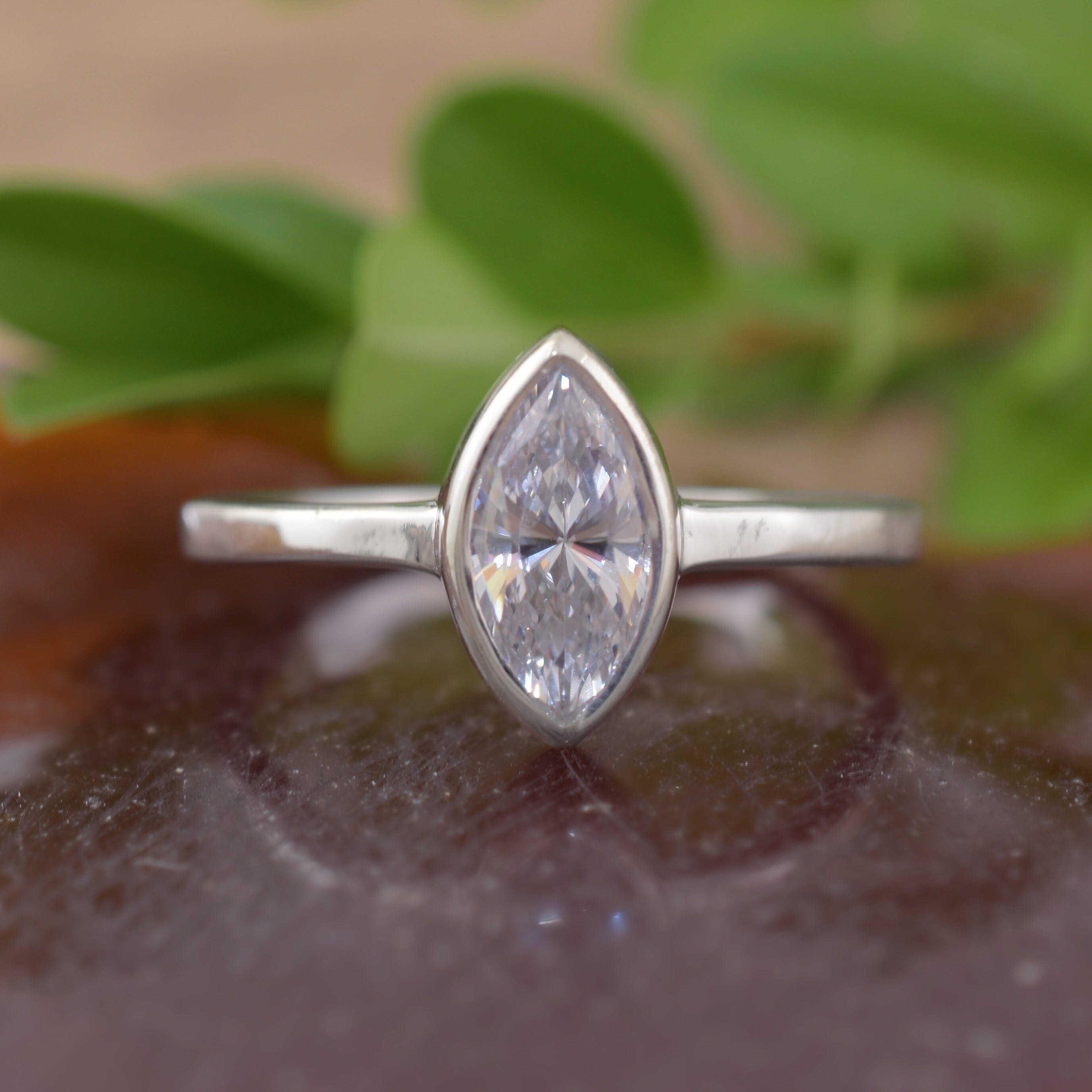 A sterling silver ring featuring a marquise cut clear CZ in the center
