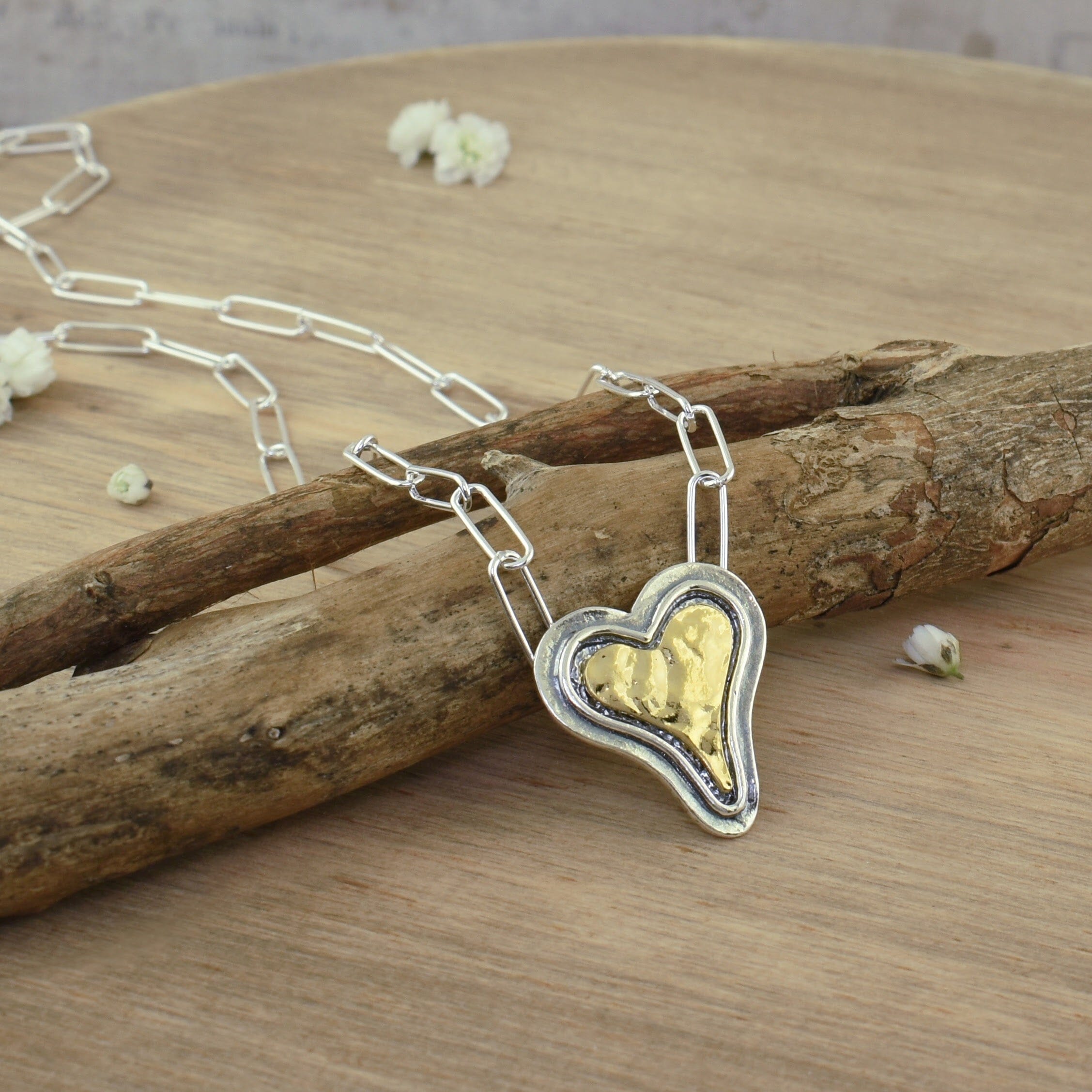 sterling silver paperclip chain necklace featuring a gold plated heart