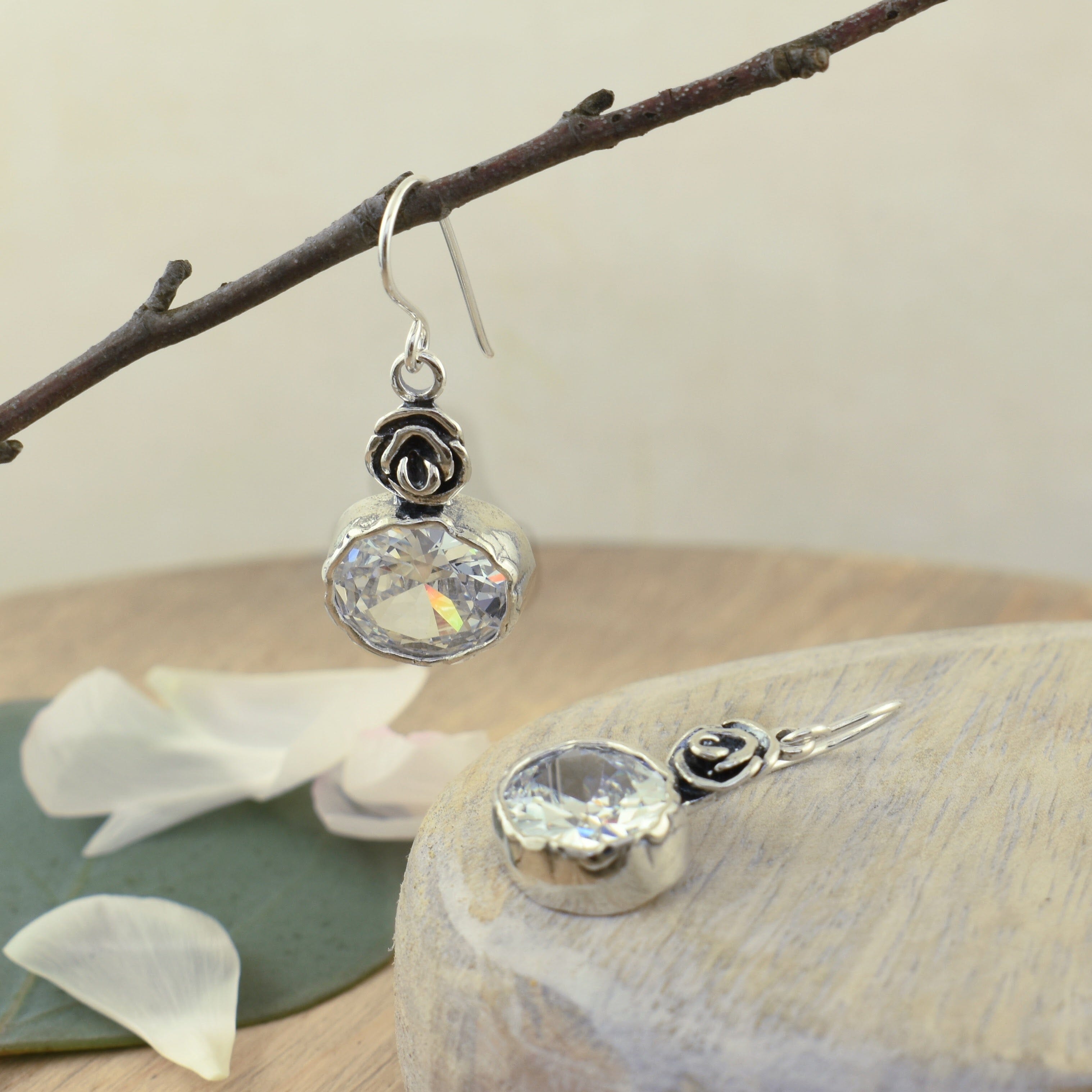 oval cz dangling earrings featuring a rose