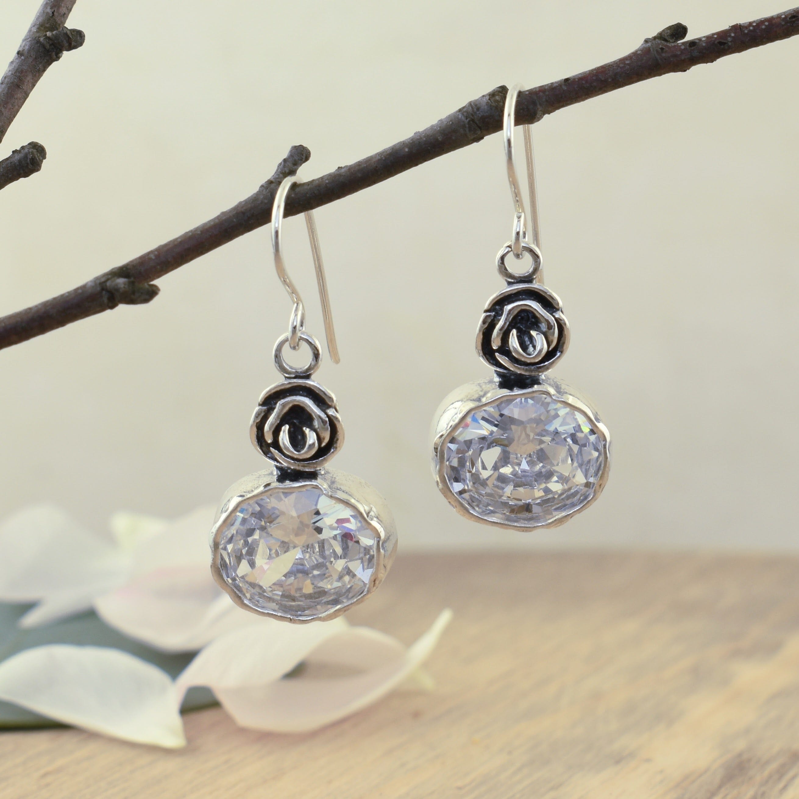 chunky dangling earrings featuring a rose and oval cz