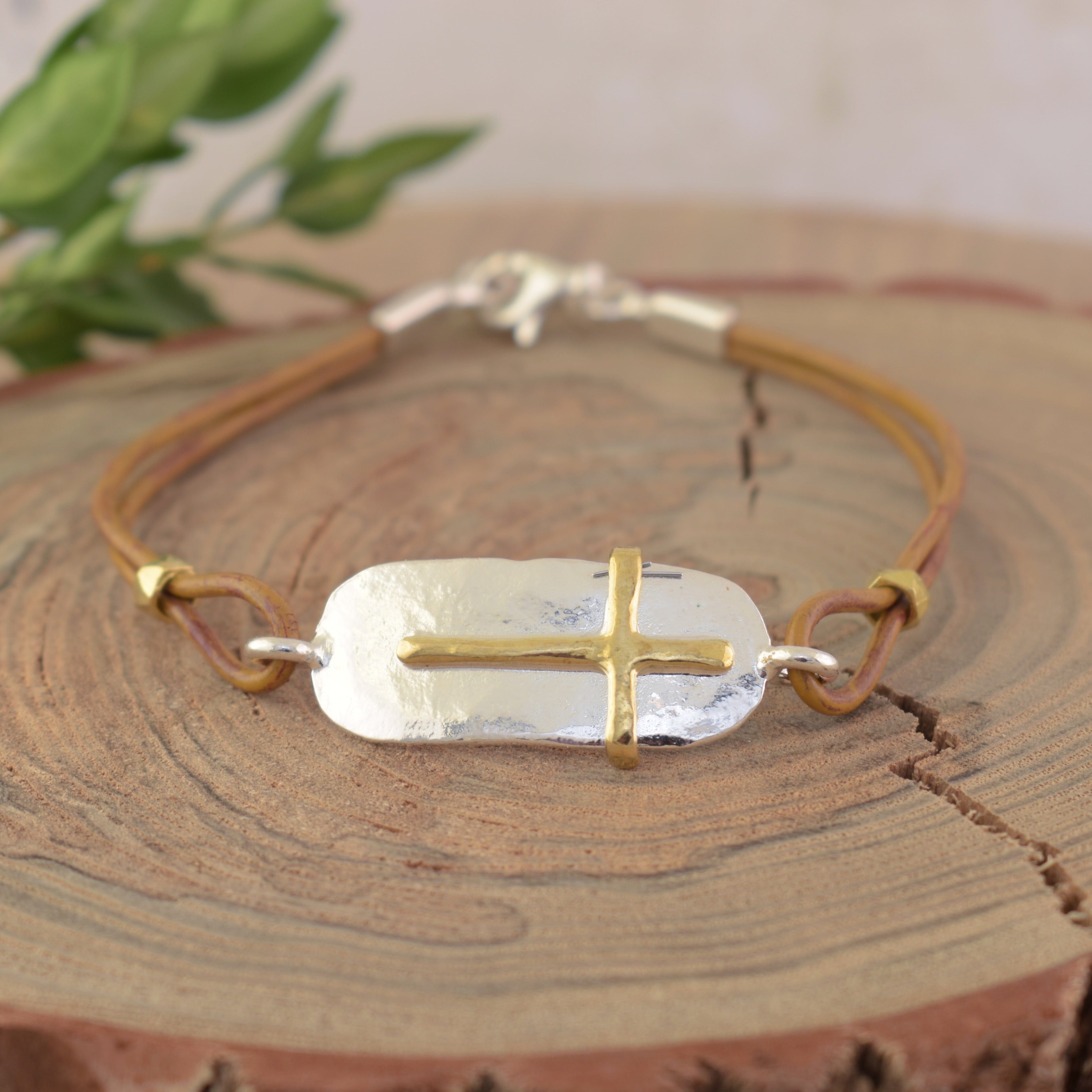 hand crafted sterling silver and gold plating with a leather band
