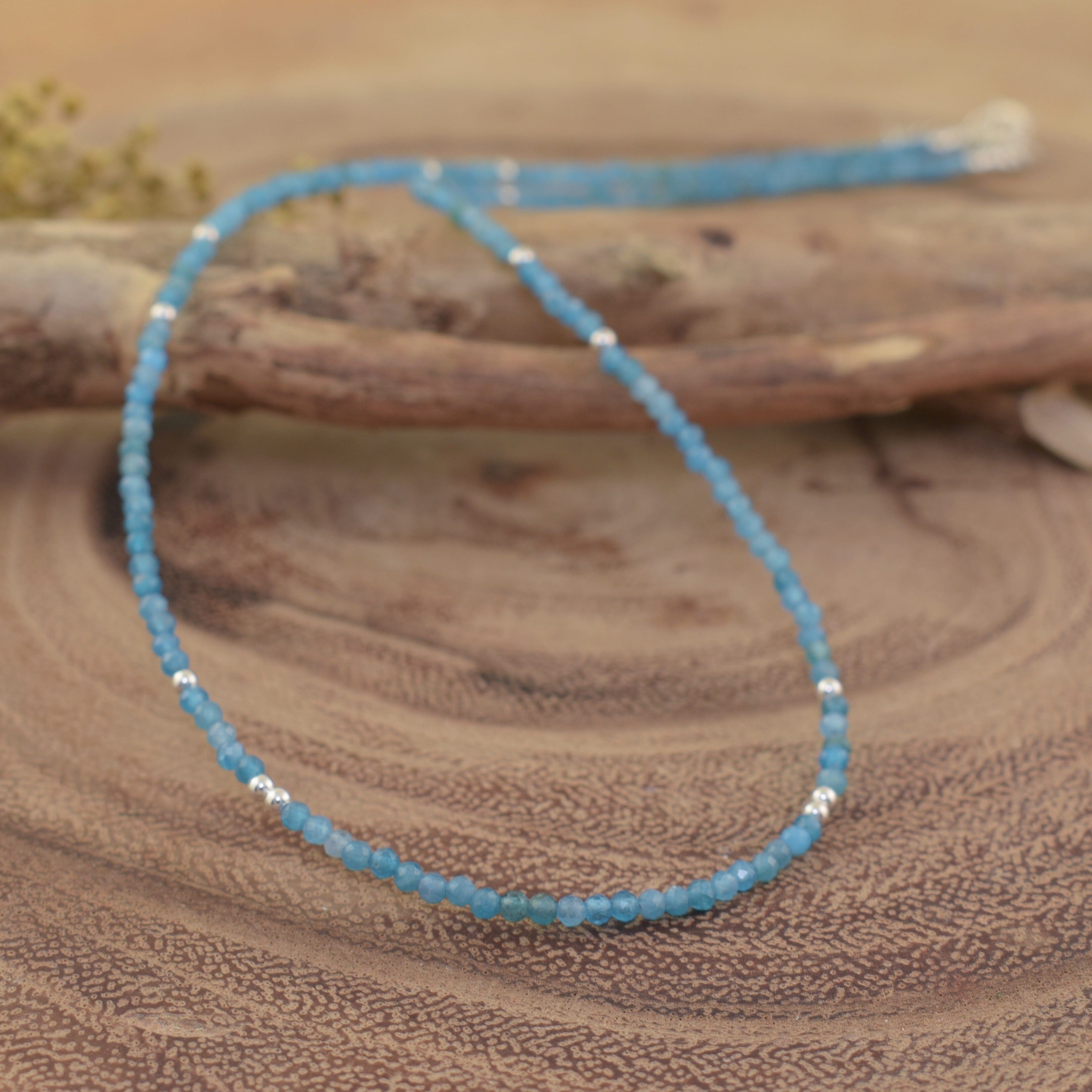 a beaded necklace made of small light blue amazonite faceted beads with silver spacer beads