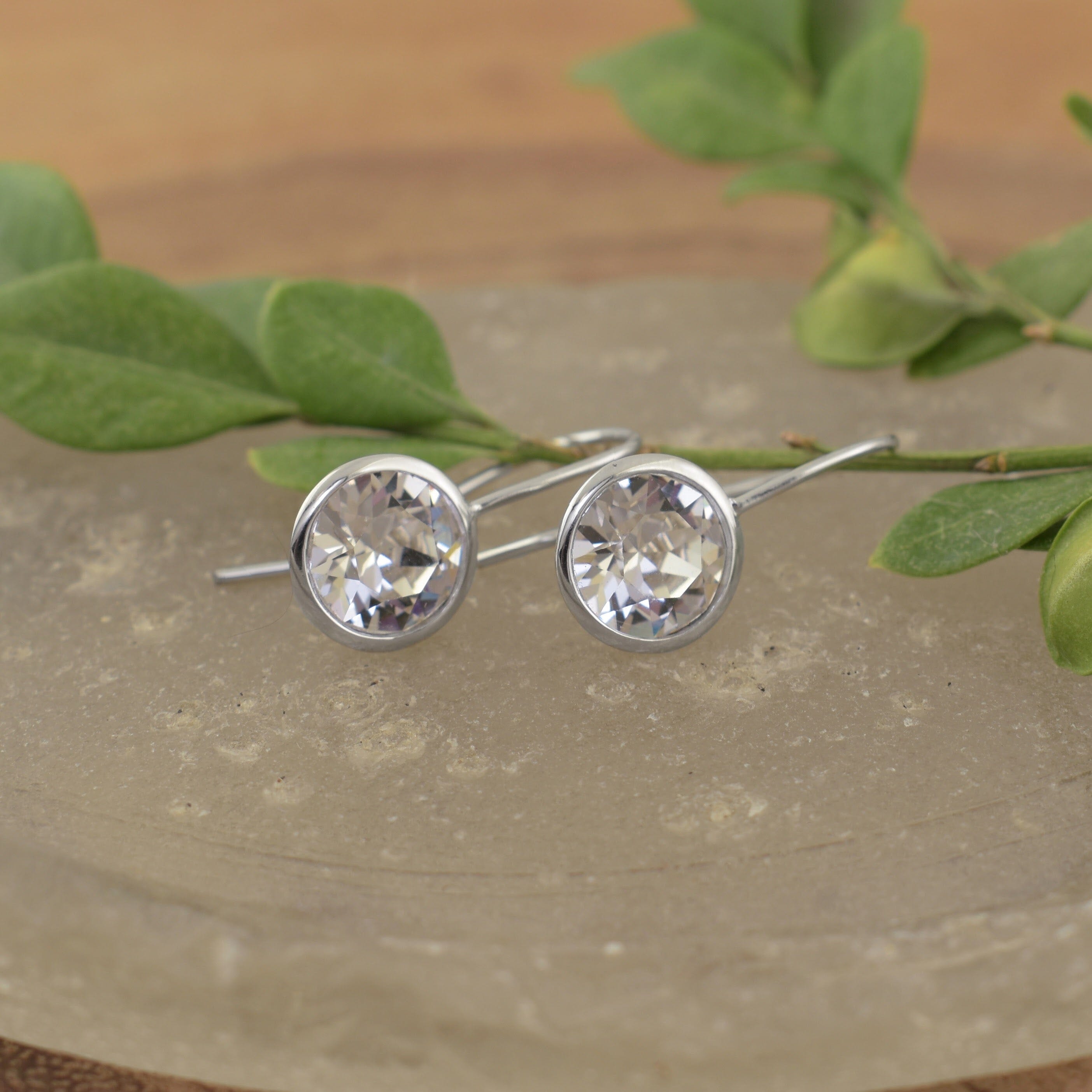 A medium-sized pair of sterling silver hook earrings with round austrian crystal stones