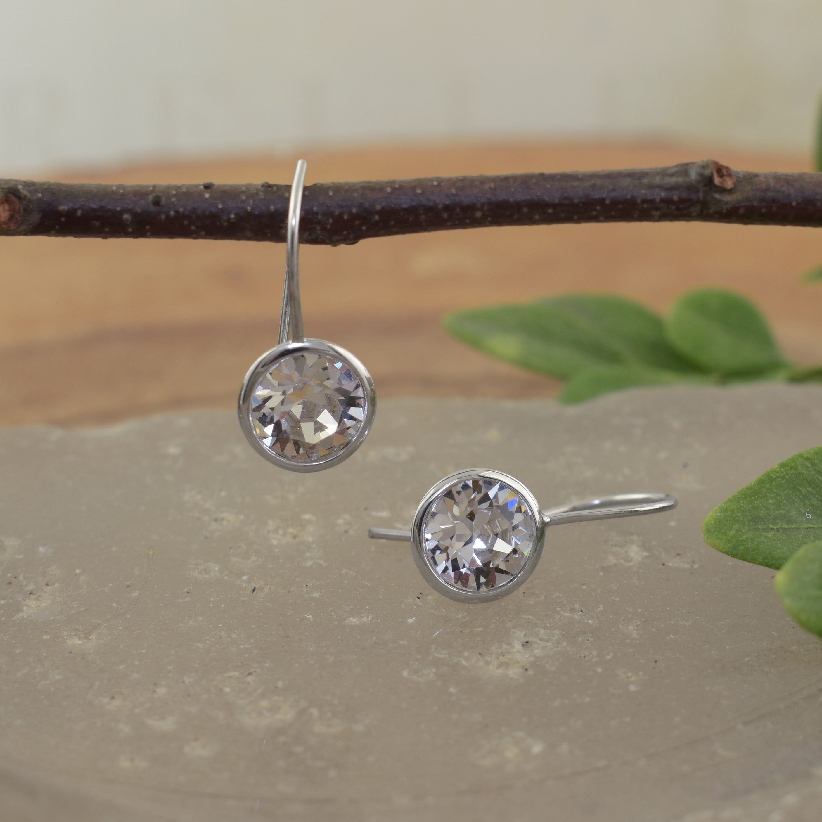 A pair of sterling silver hook earrings featuring round austrian crystal stones
