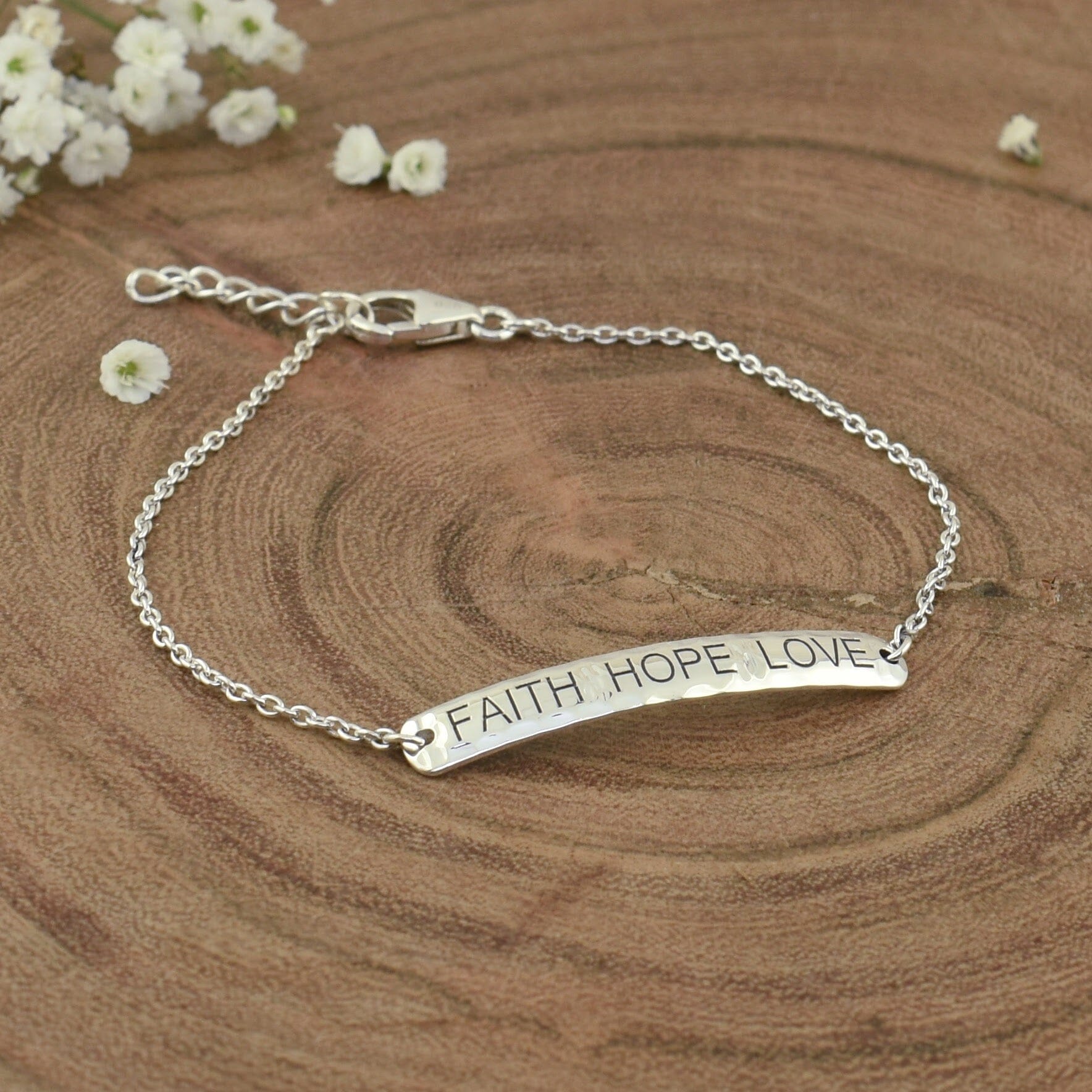 dainty sterling silver bracelet engraved with faith, hope, and love