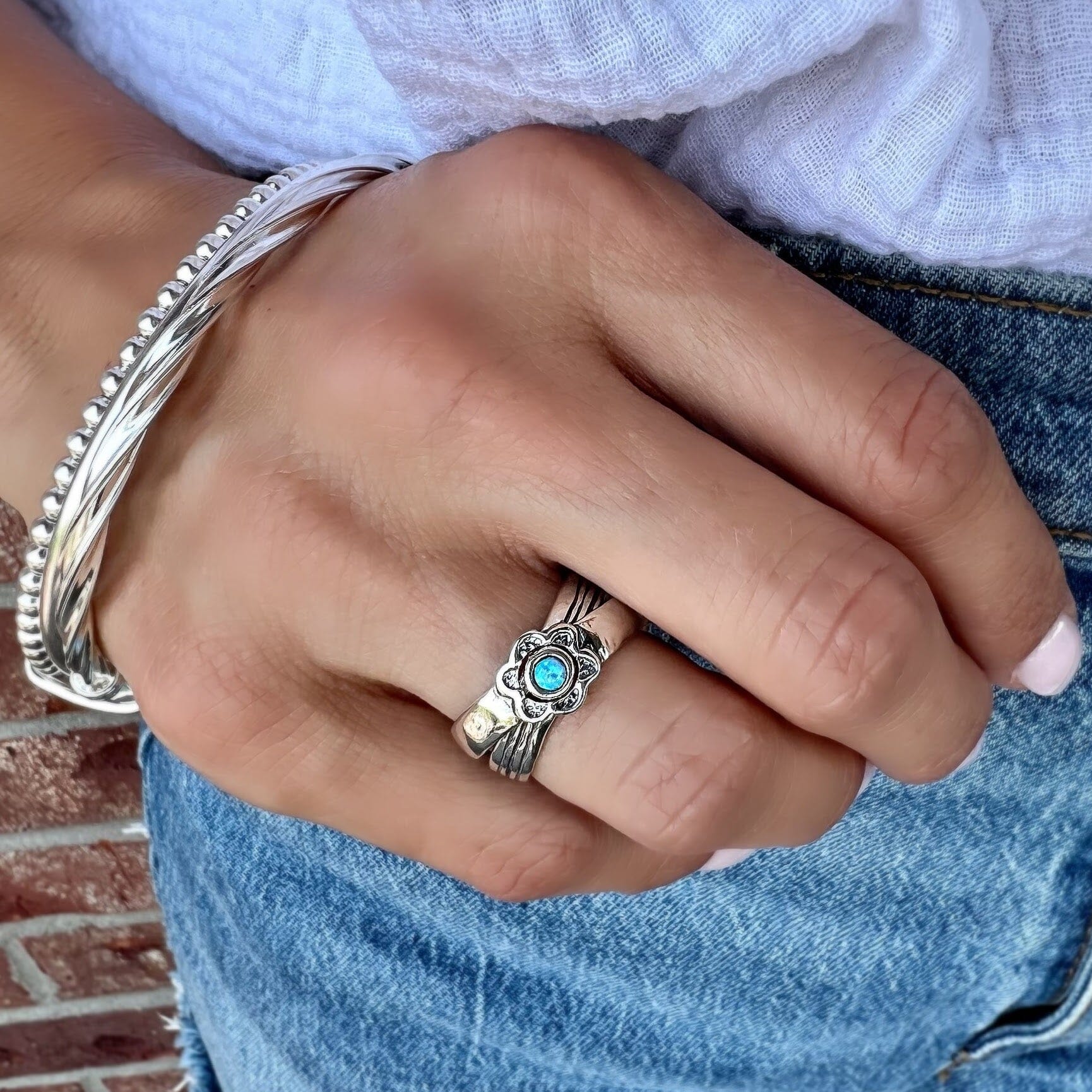 interlocking opal ring paired with a trio bangle