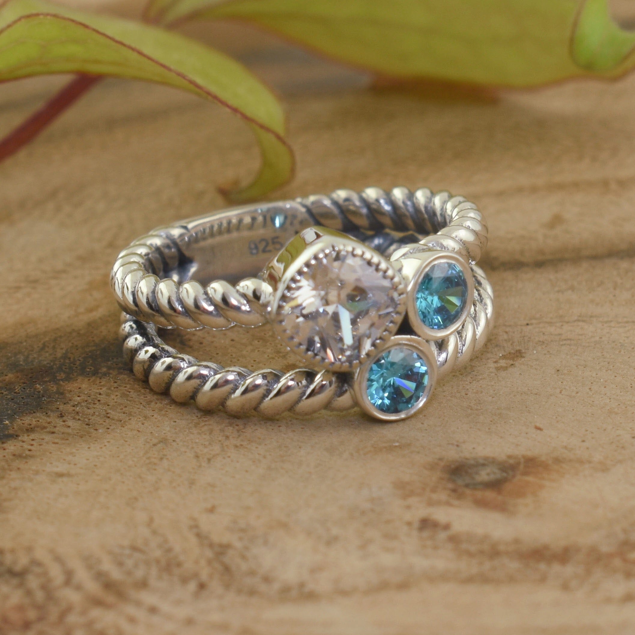 .925 sterling silver ring with clear and blue bezel set cz stones