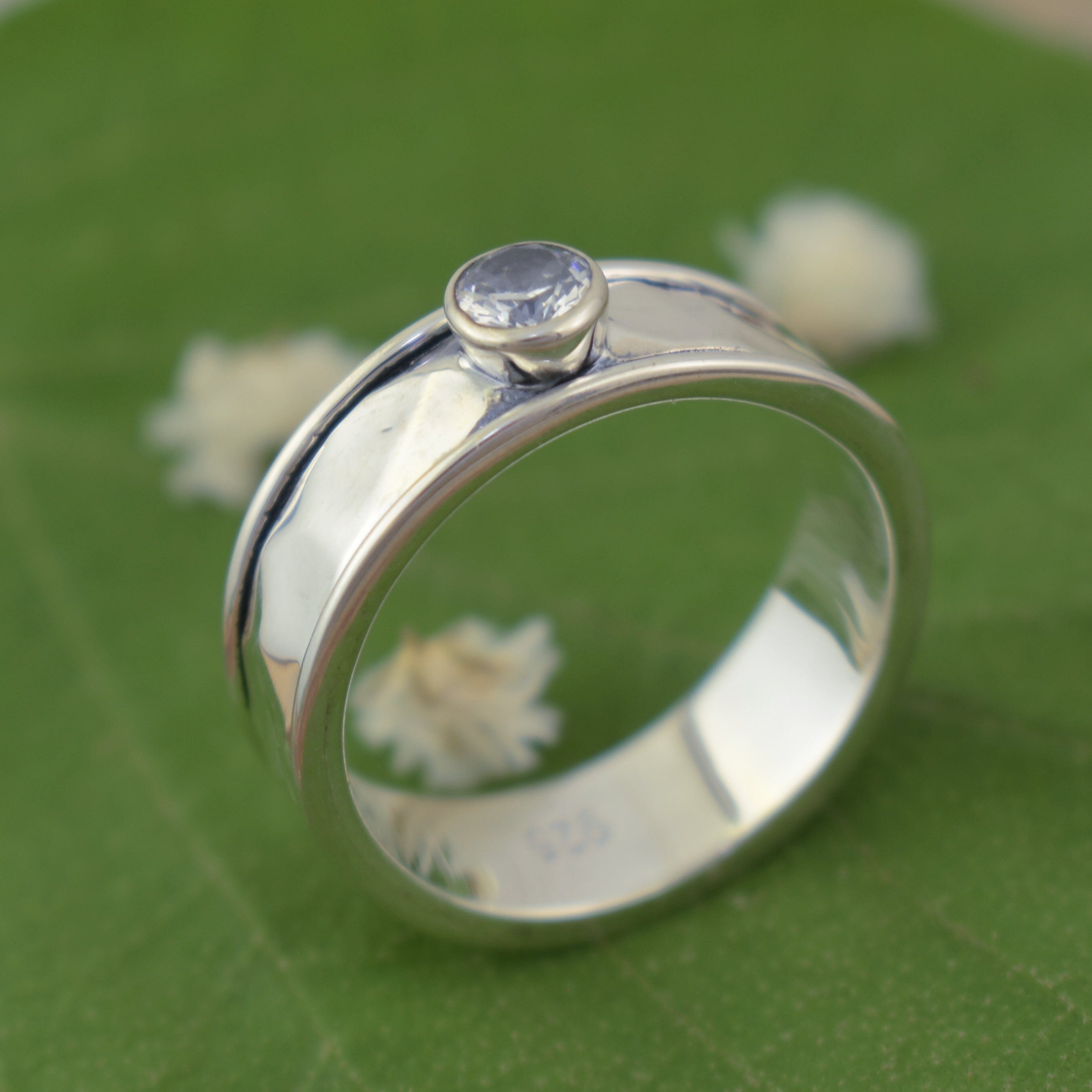 Spinner style sterling silver ring featuring cubic zirconia