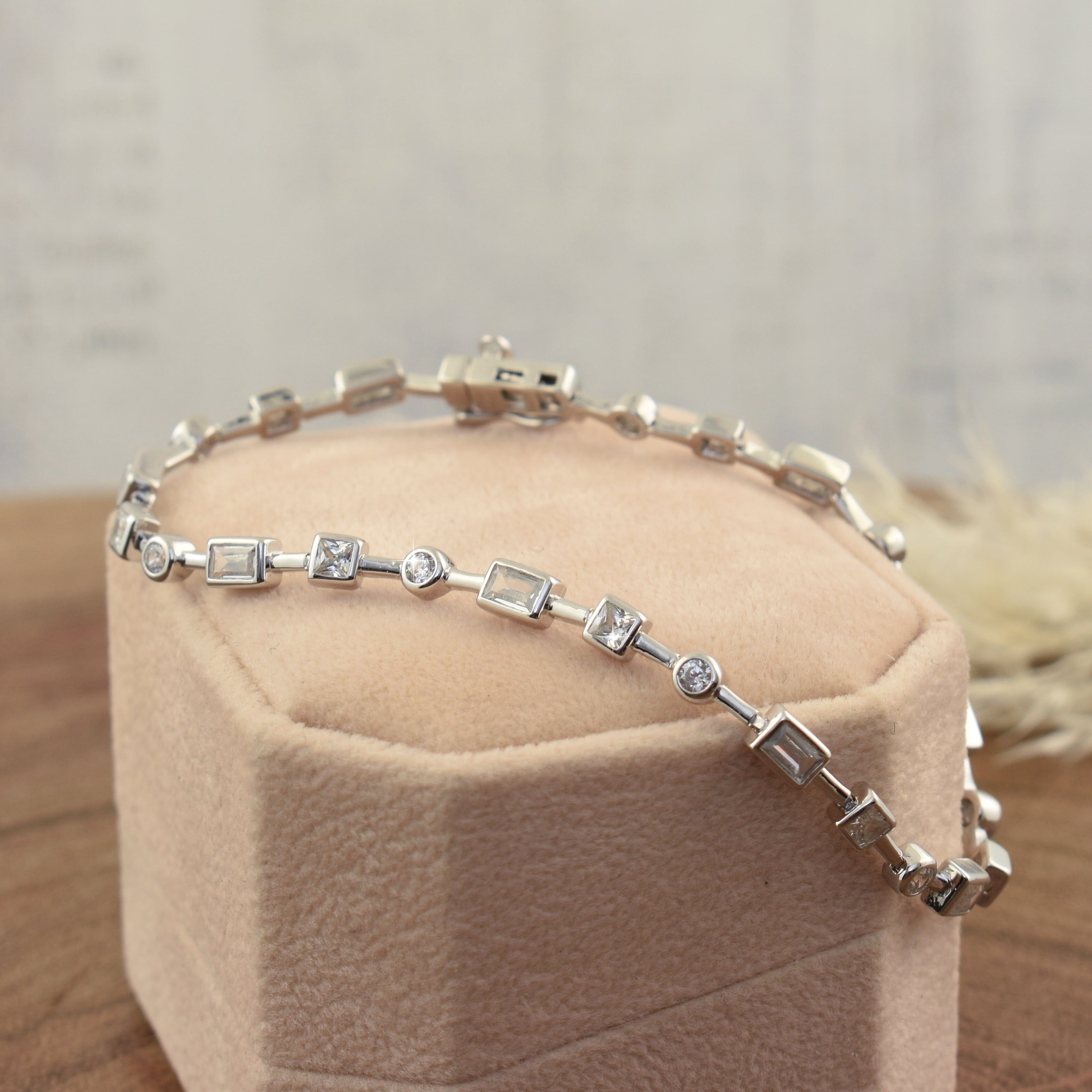 sterling silver and rhodium plated bracelet with three shapes of CZs throughout