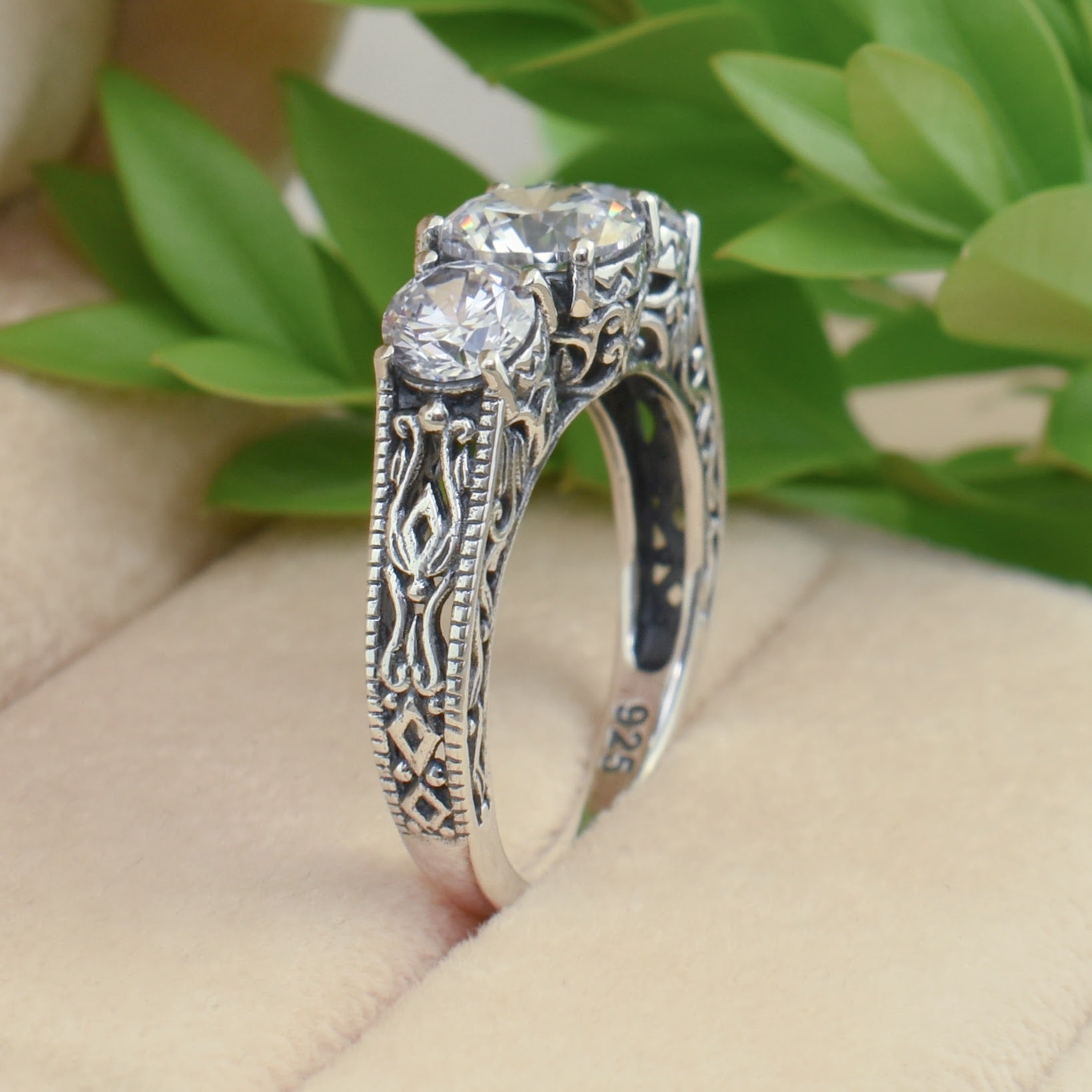 sterling silver three prong-set cubic zirconia and filigree detail