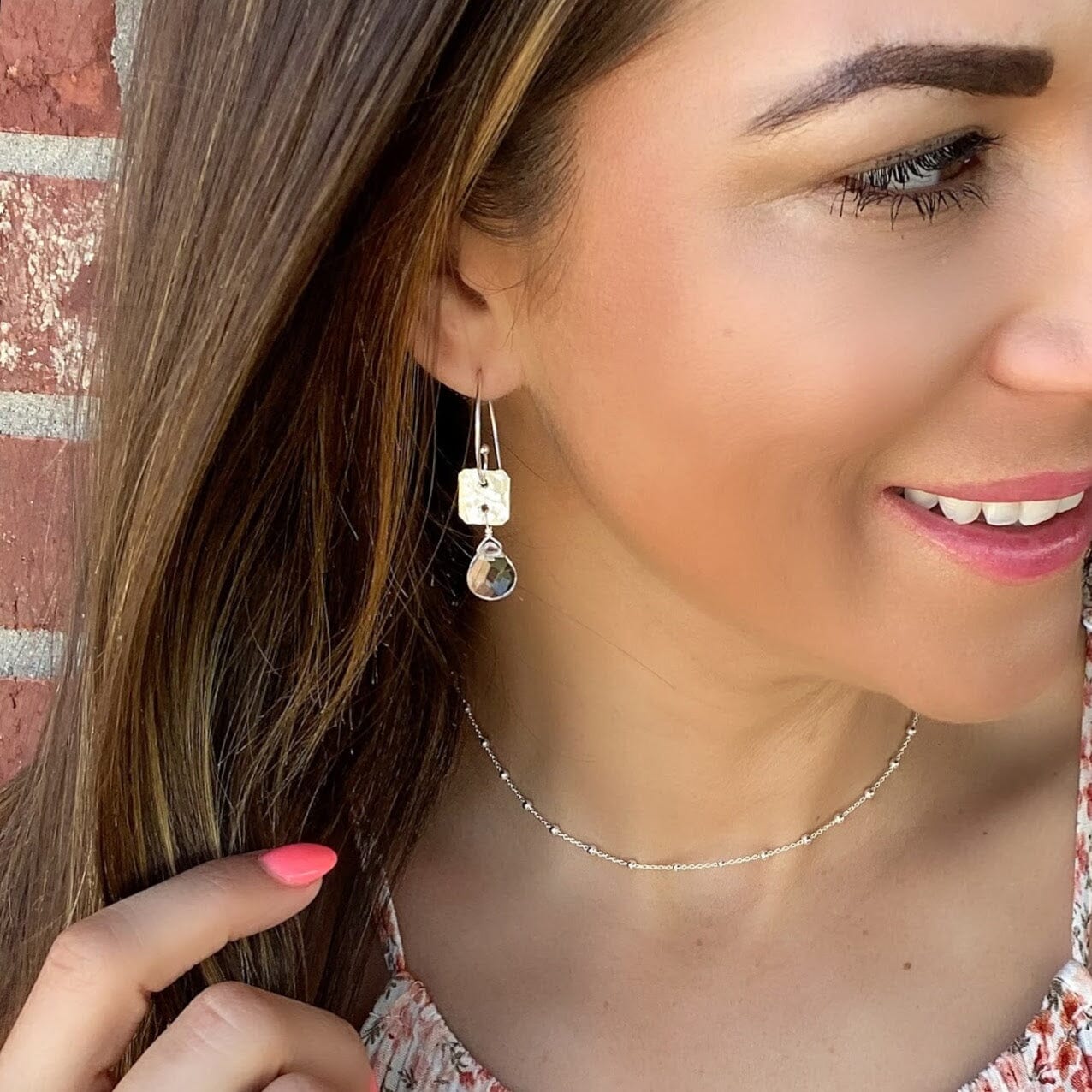 dangling sterling silver and clear crystal earrings with a hammered finish