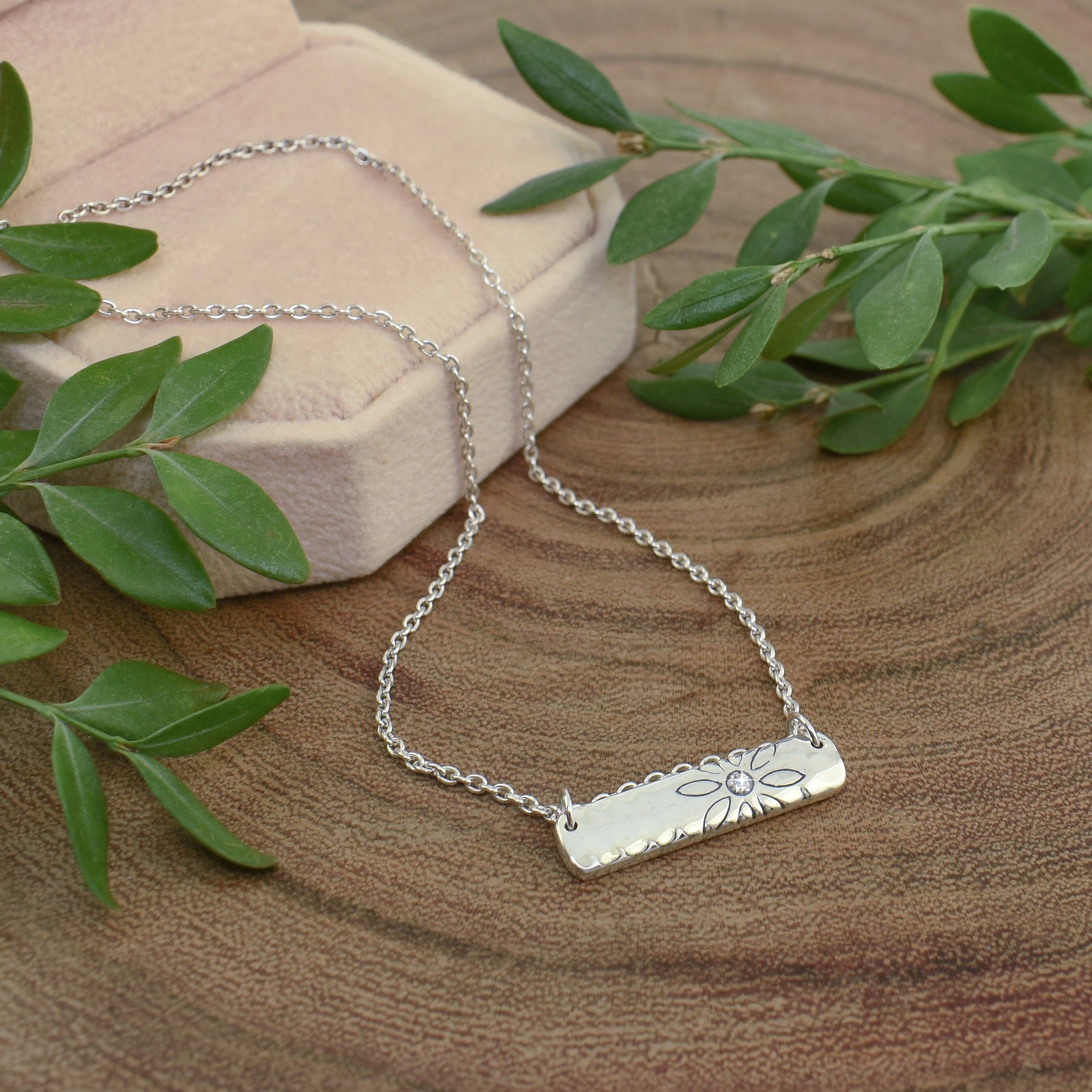 dainty .925 sterling silver necklace featuring a flower and tiny diamond