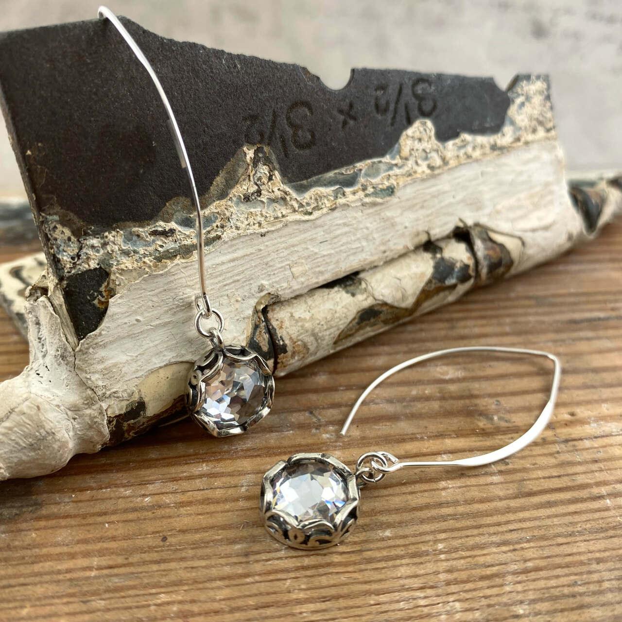 Handcrafted sterling silver earrings featuring large CZ's