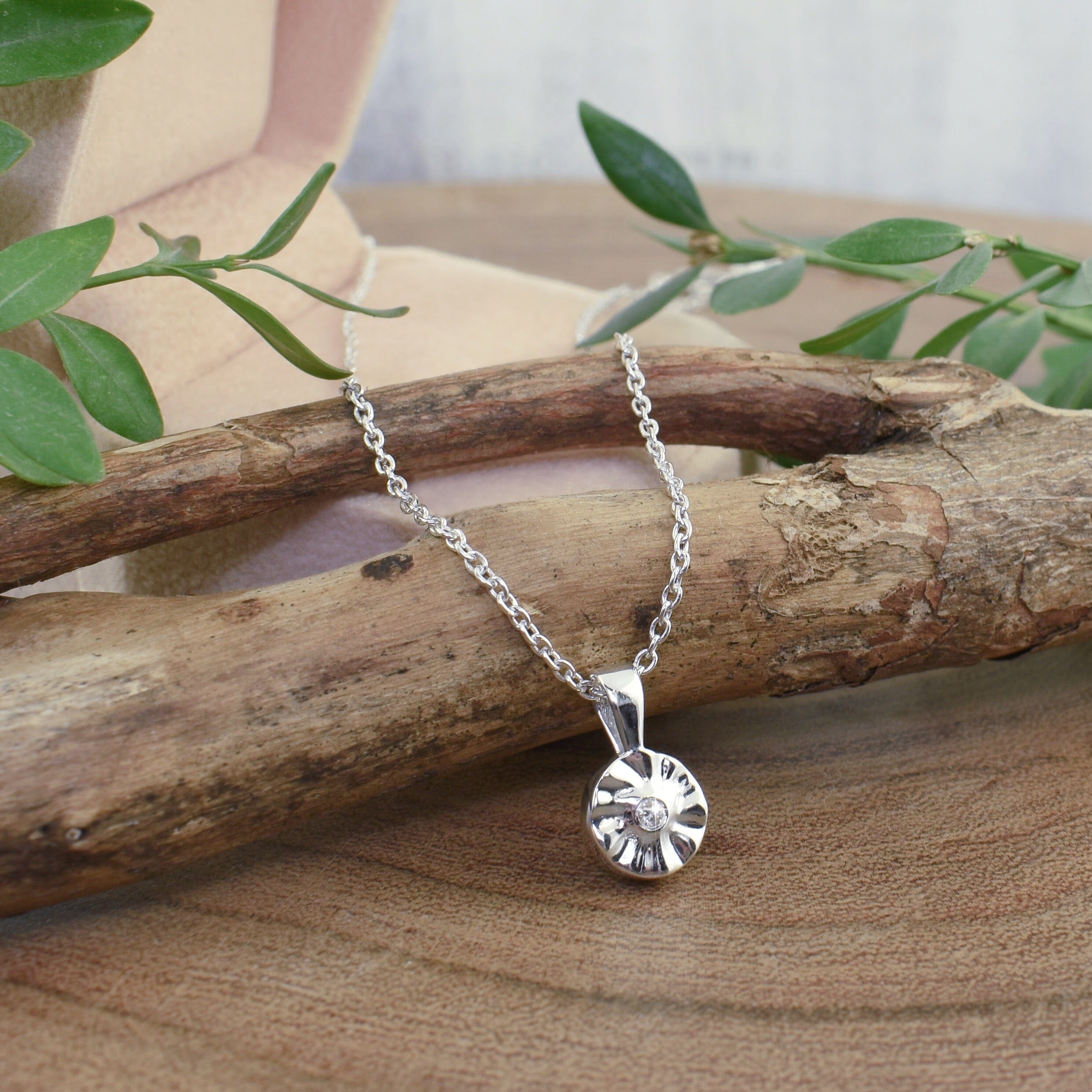 dainty .925 sterling silver flower necklace featuring a tiny diamond