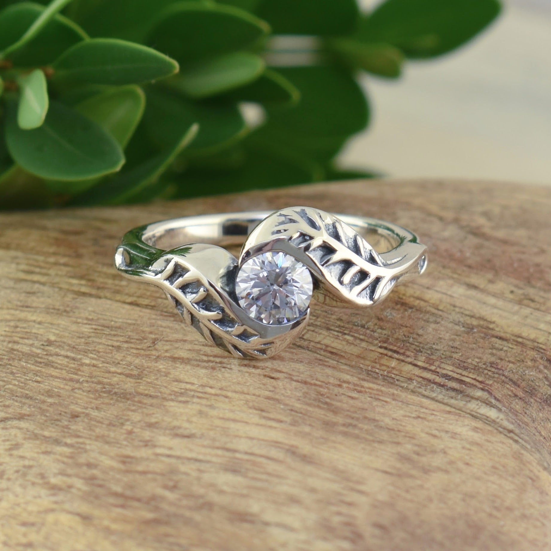 dainty antique-style ring with a round cz and leaf design