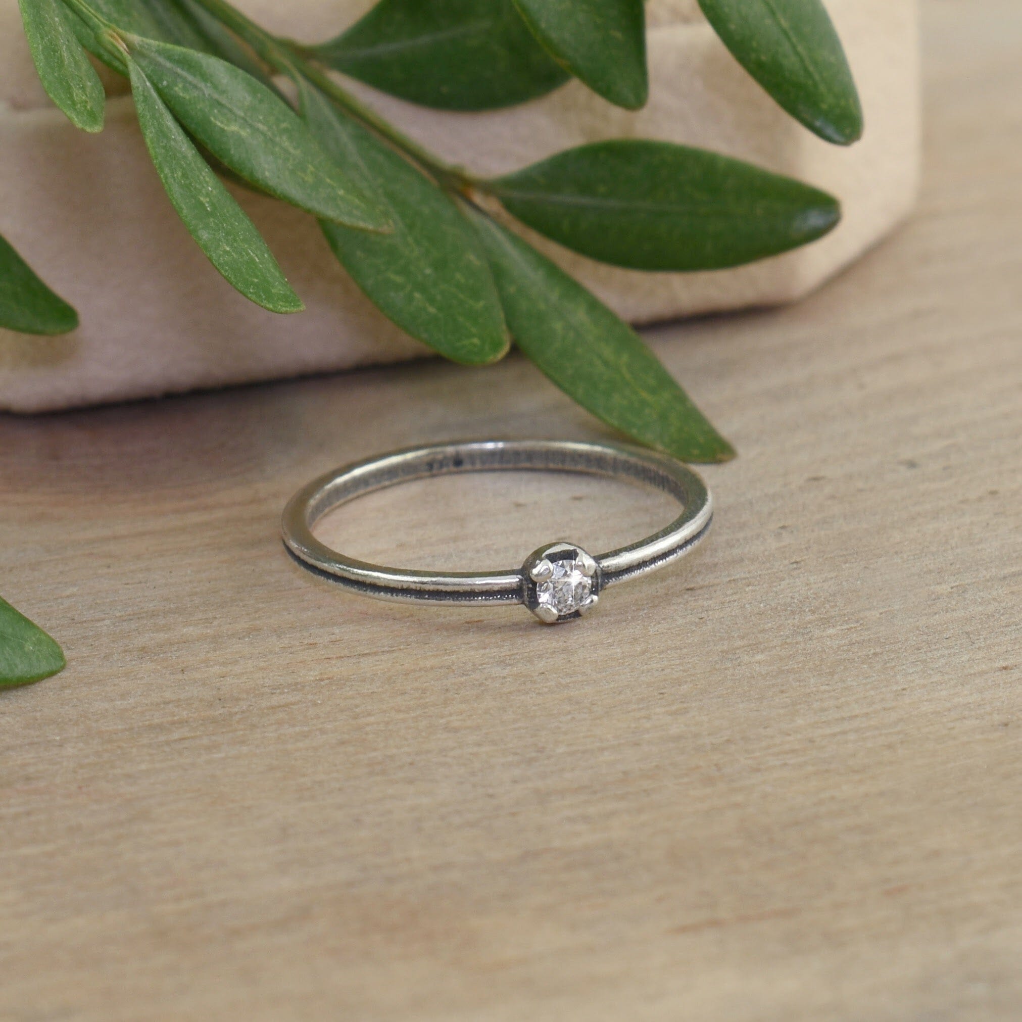 dainty .925 sterling silver ring featuring a diamond
