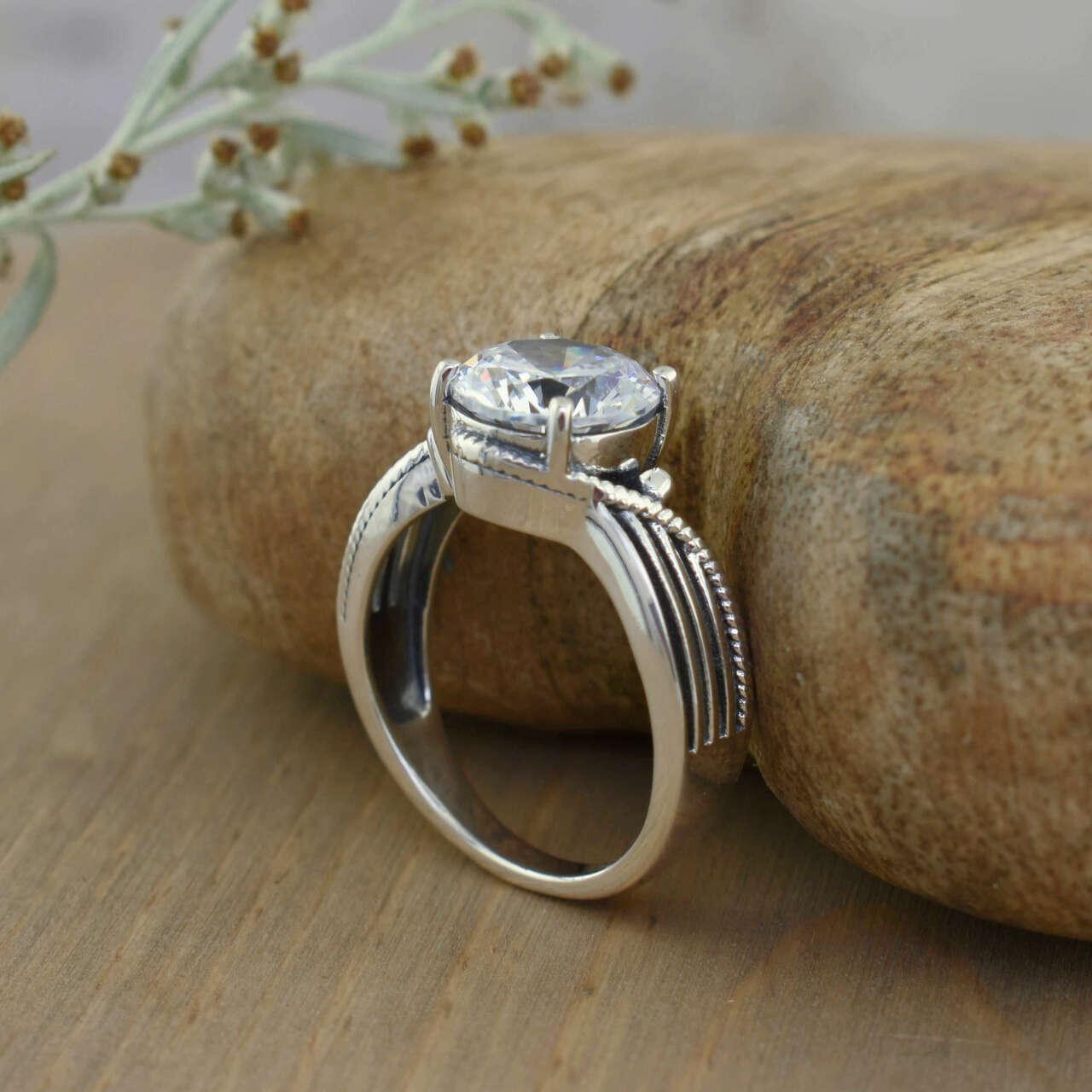 Designer ring in sterling silver and center prong set round faceted CZ