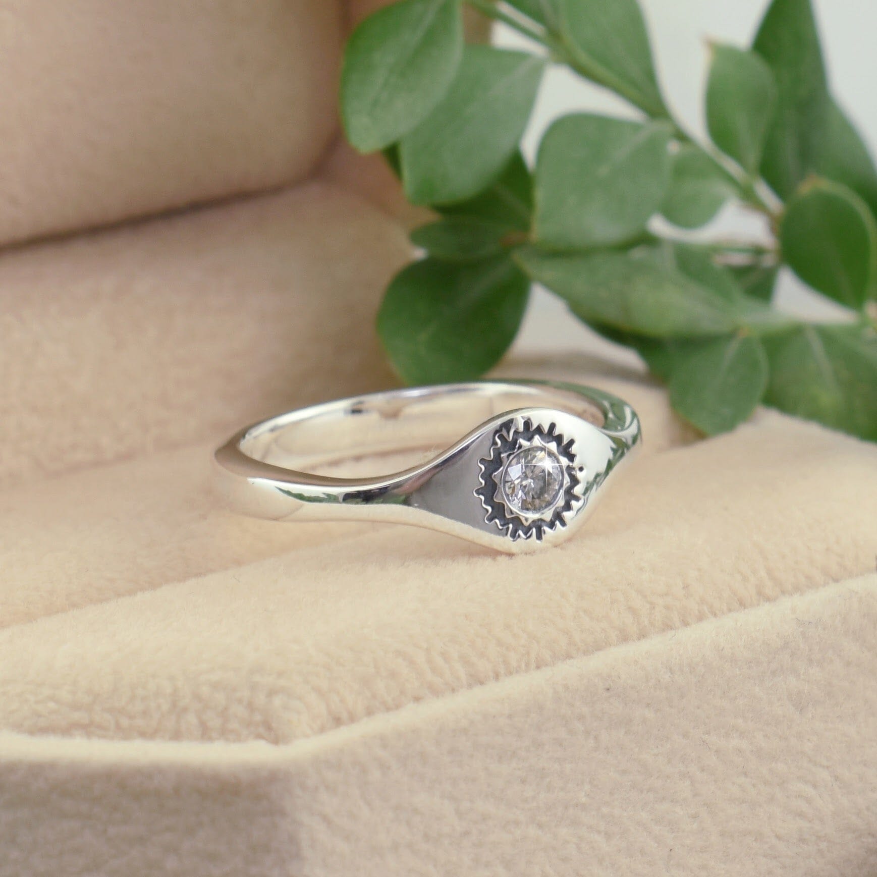 dainty .925 sterling silver ring featuring a diamond with oxidation around the stone