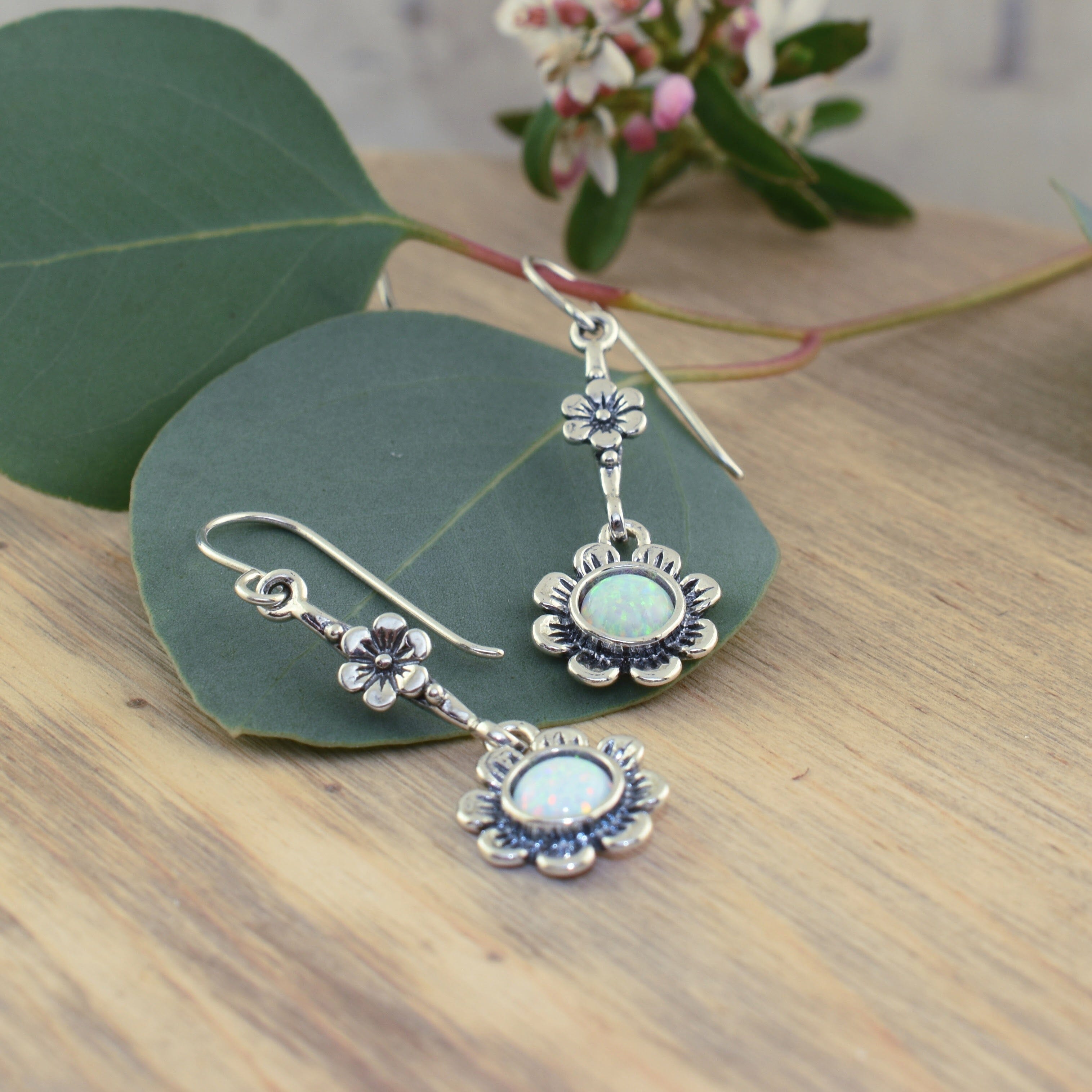 dangling sterling silver flower earrings with white reconstructed opal stones
