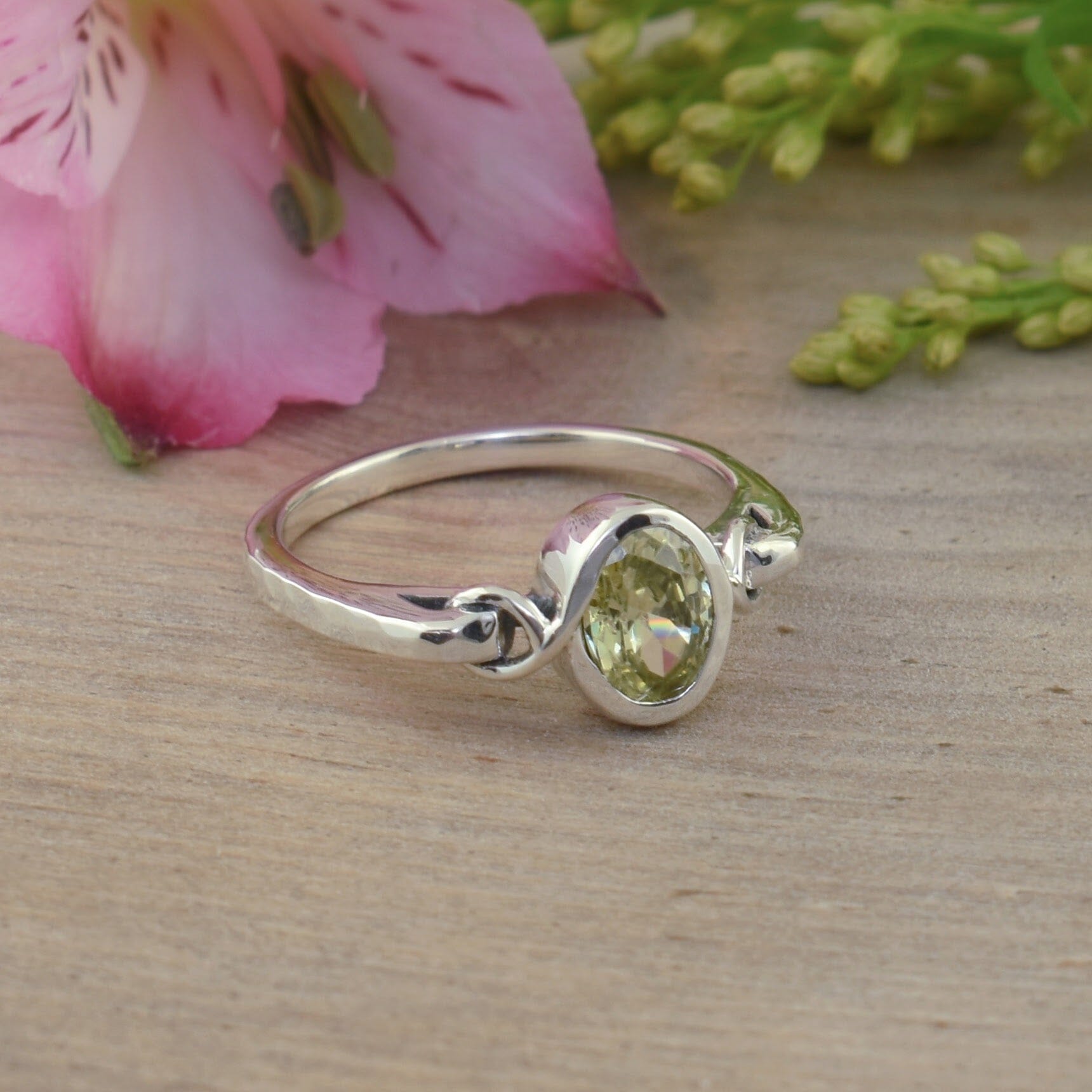 dainty sterling silver featuring an oval peridot cz